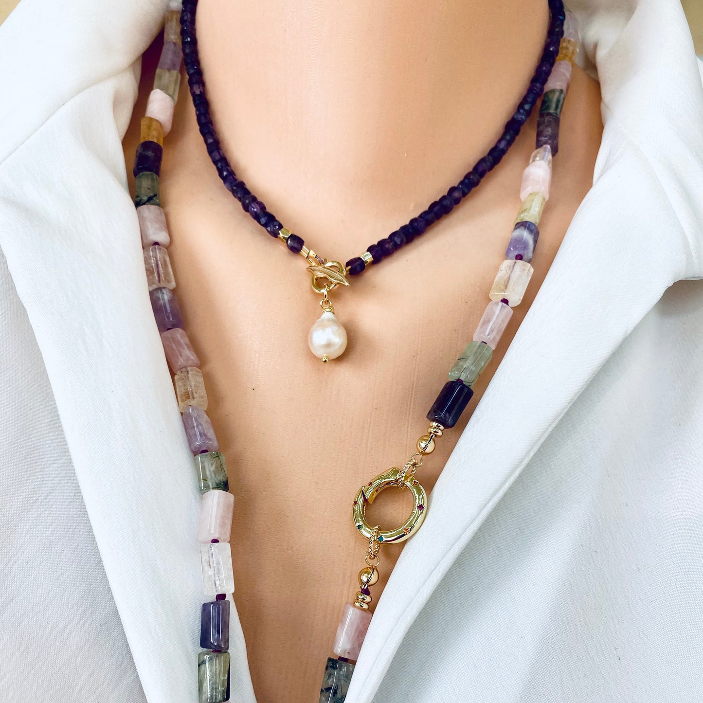 Amethyst toggle necklace with baroque pearl charm on a mannequin, showcasing purple hues and elegant design.
