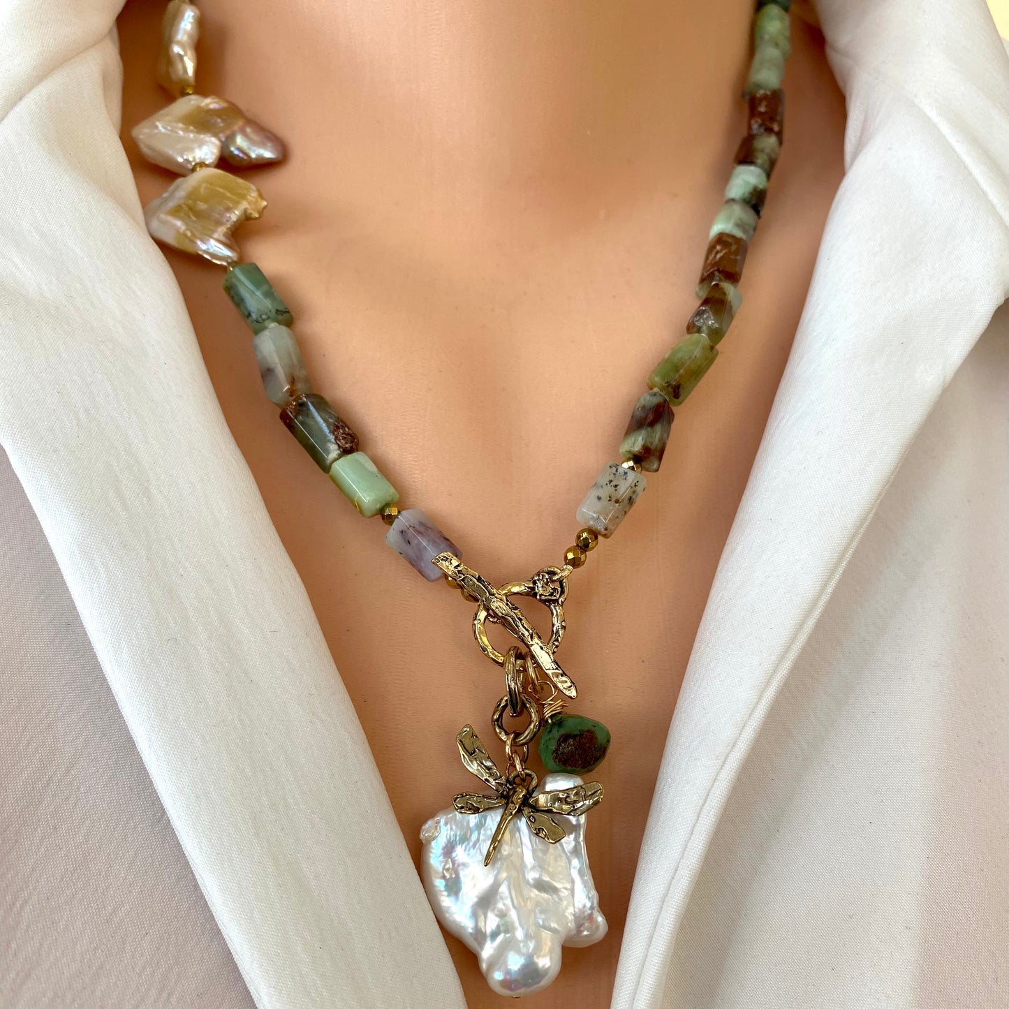 Chrysoprase necklace with dragonfly charm and baroque pearl, showcasing vibrant green gemstones and unique design.