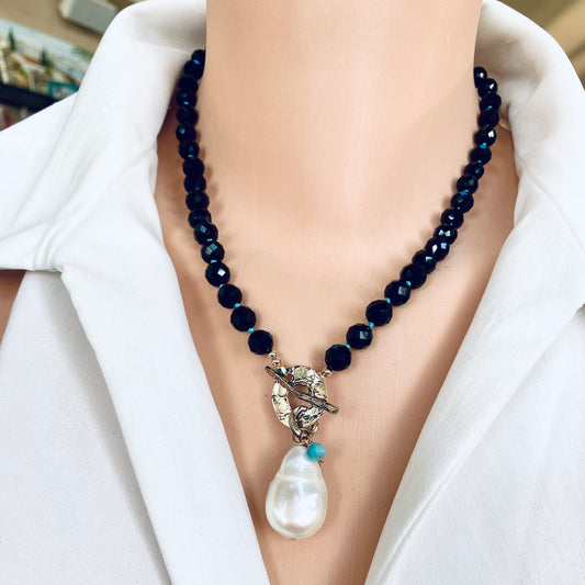 Black tourmaline baroque pearl toggle necklace worn on model showing pearl pendant and charms