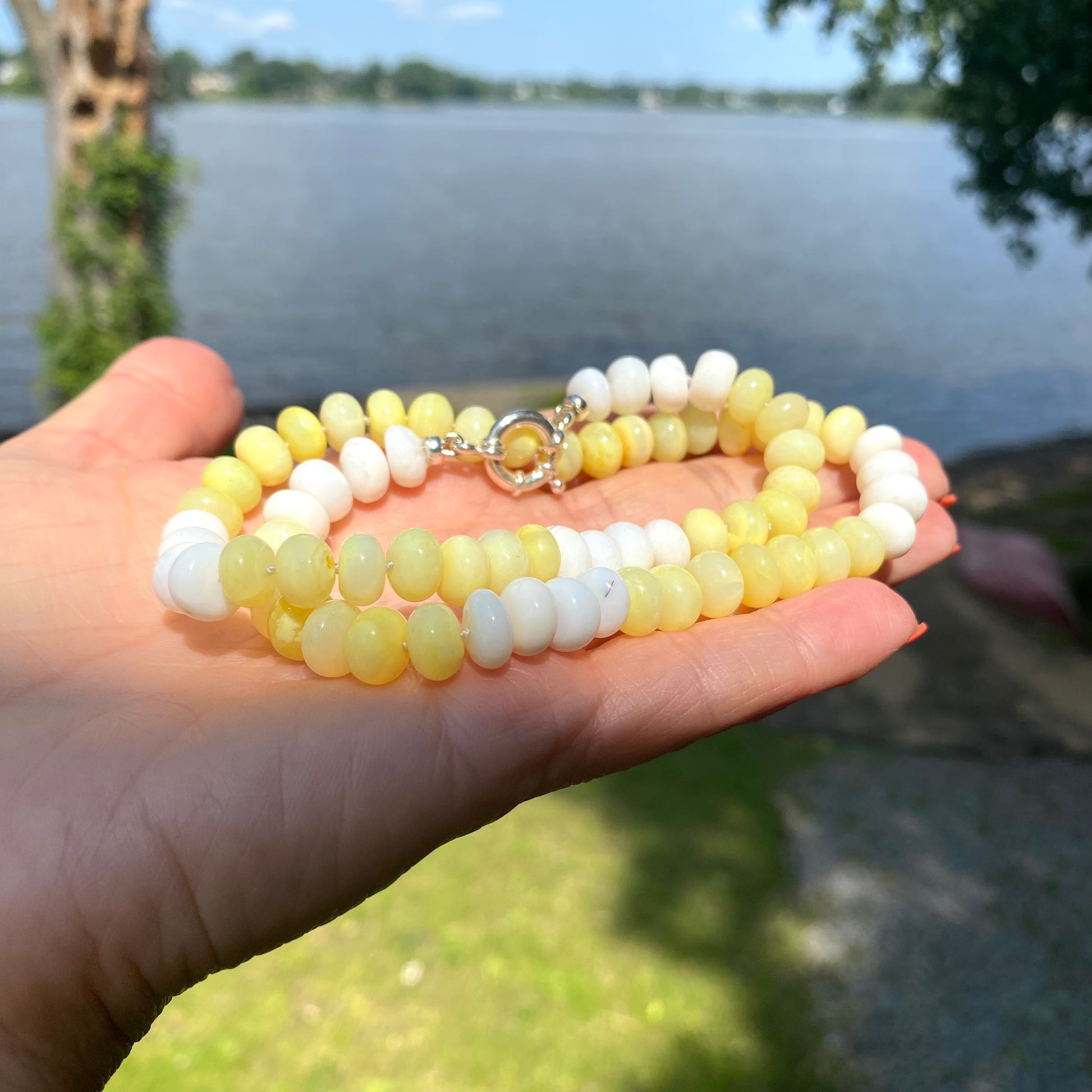 Handmade yellow opal beaded necklace with sterling silver clasp outdoors