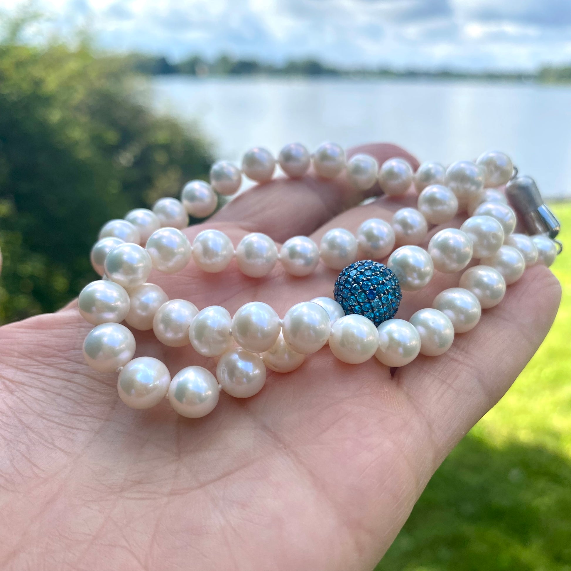 Pearl necklace featuring turquoise CZ bead, showcasing handcrafted design by Canadian artisans. Elegant and timeless jewelry.