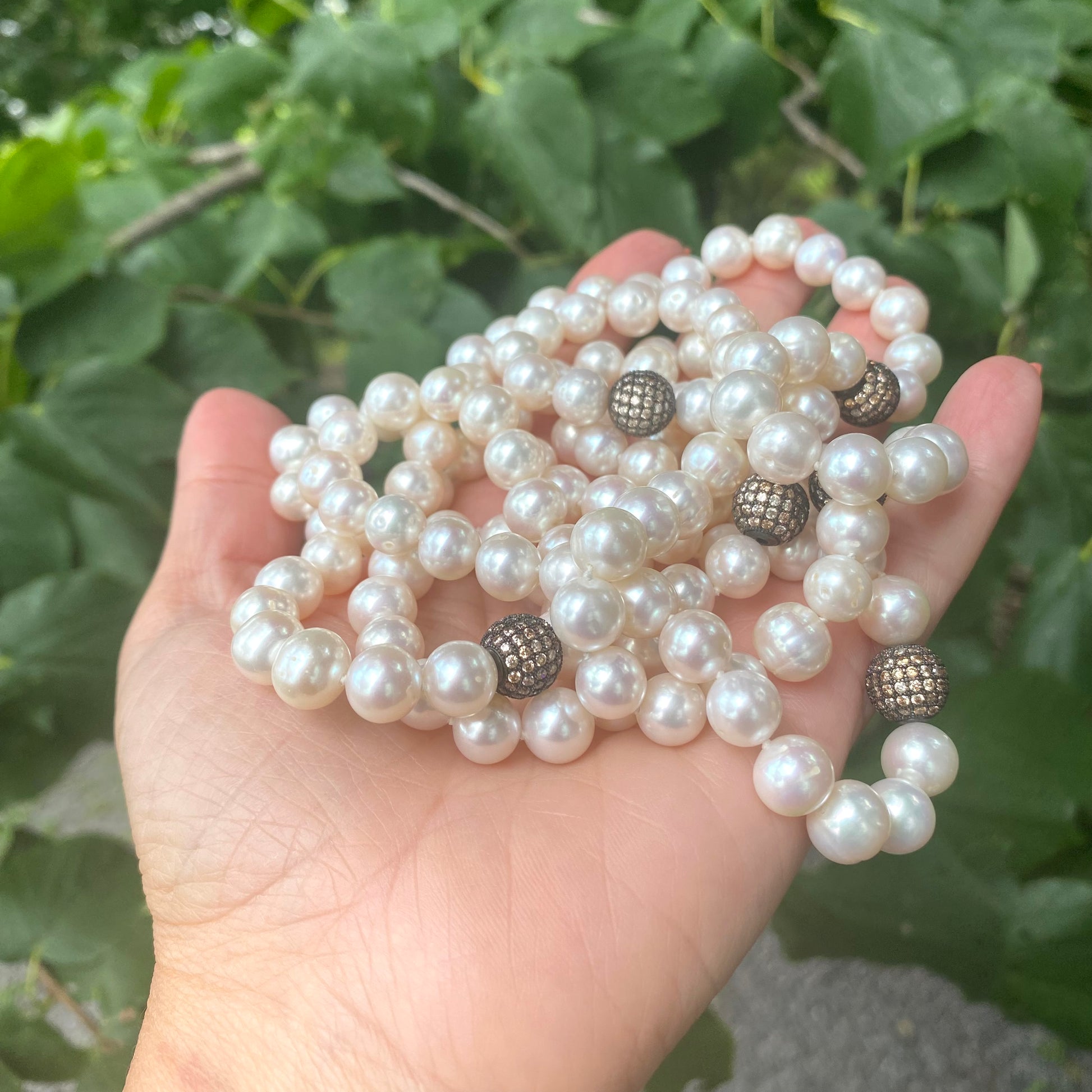 Freshwater pearl necklace with champagne CZ silver beads photographed outdoors, designed and handmade in Canada.