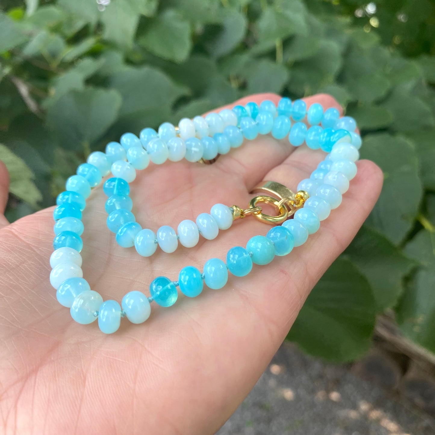 Opal candy necklace featuring sky blue opal rondelle beads with a gold clasp, showcasing a spring and summer style.