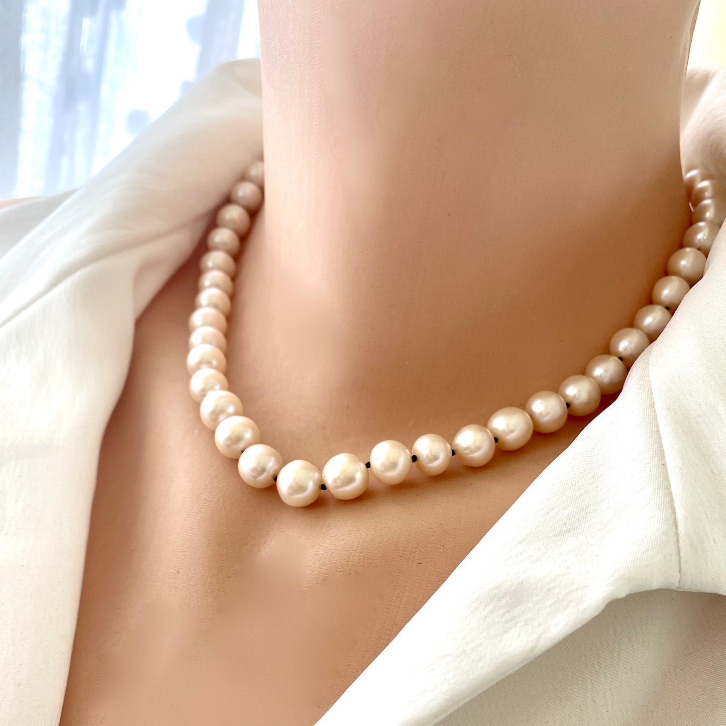 Off white pearl choker necklace worn on mannequin, front view