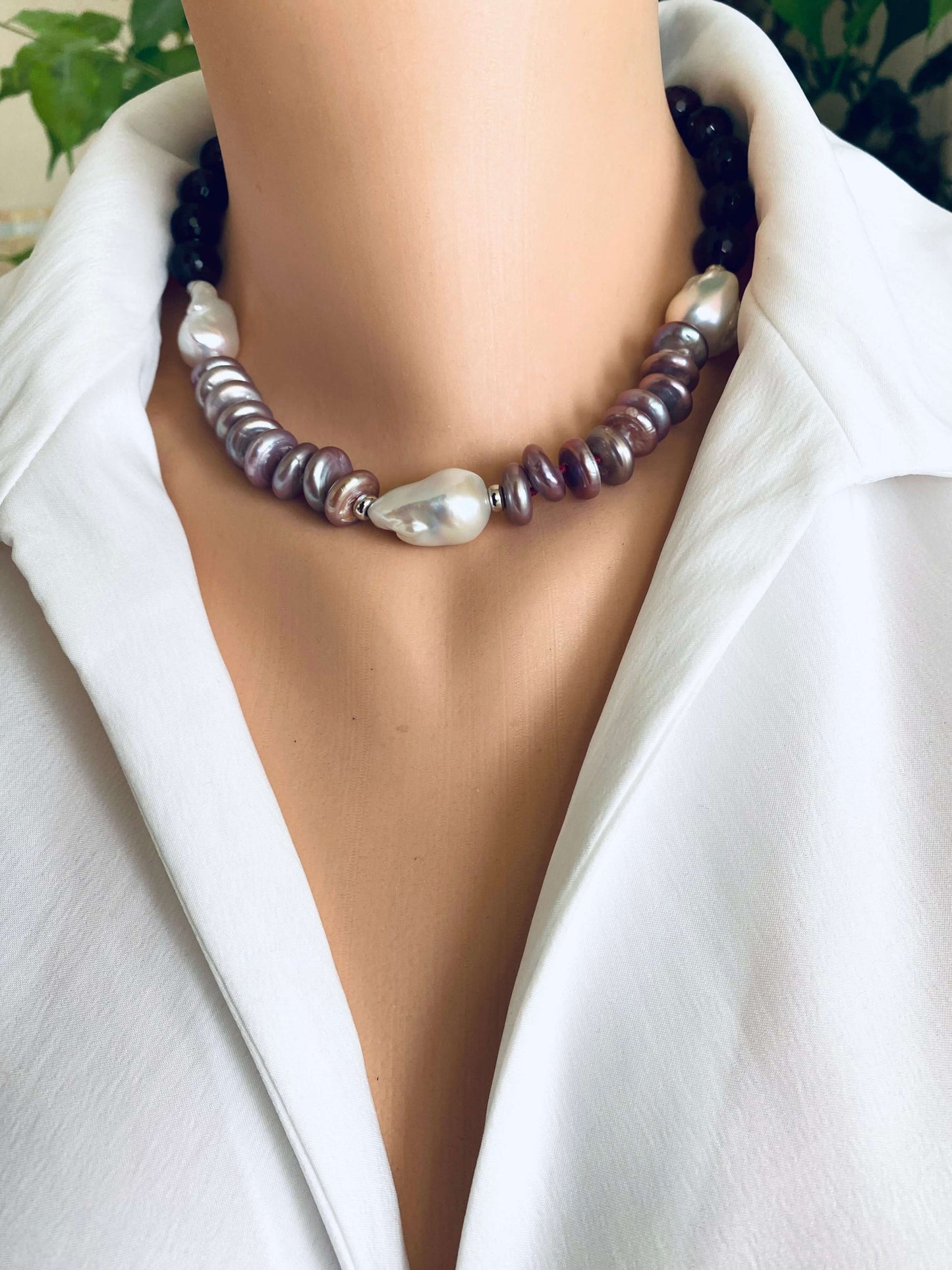 Garnet pearl necklace featuring baroque and coin pearls, displayed elegantly on a mannequin with a white blouse.