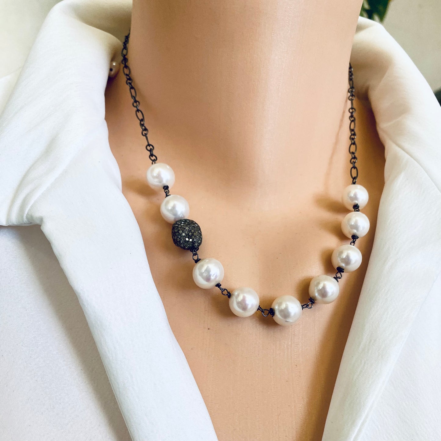 Pearl necklace wire wrapped in silver, featuring high-lustre freshwater pearls and diamond pavé oxidized silver bead.