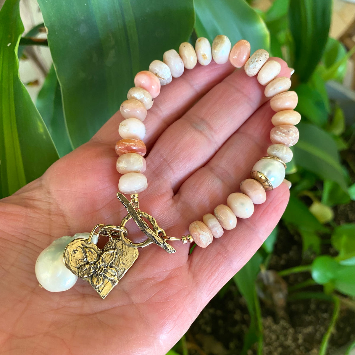 Pink opal bracelet with heart and baroque pearl charm handcrafted with smooth pink opal beads.