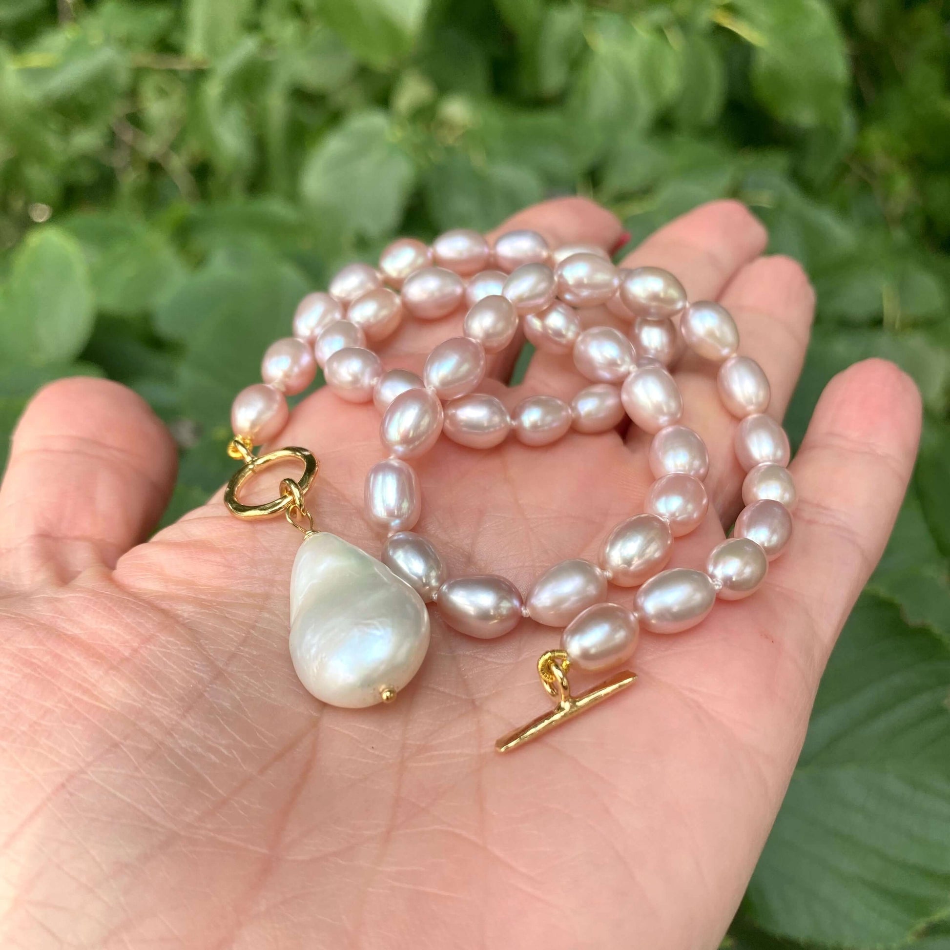 Pink pearl toggle necklace with baroque pearl highlighting hand-knotted pearls and gold vermeil clasp