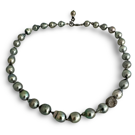 A dark gray baroque pearl necklace with a textured silver-toned bead accent, displayed on a clean white background.