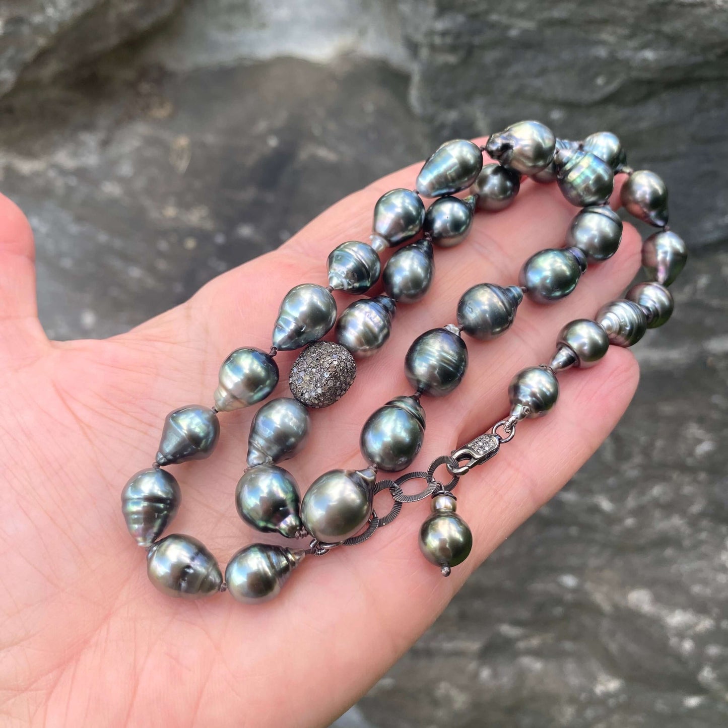 Tahitian baroque pearl necklace with champagne diamonds – 16" design displayed on a hand with natural grey pearls.
