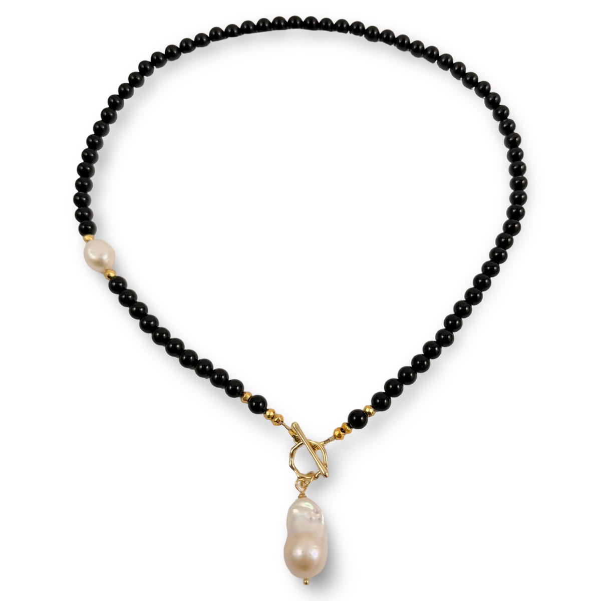 The pearl Solitaire Toggle necklace, back onyx and gold coated pyrite beads, finished with a gold plated toggle clasp and a beautiful white baroque pearl pendant
