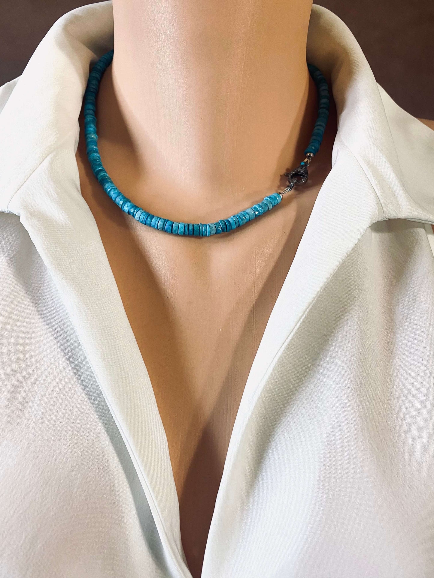 Turquoise howlite beaded necklace with oxidized silver pavé clasp worn on a mannequin.