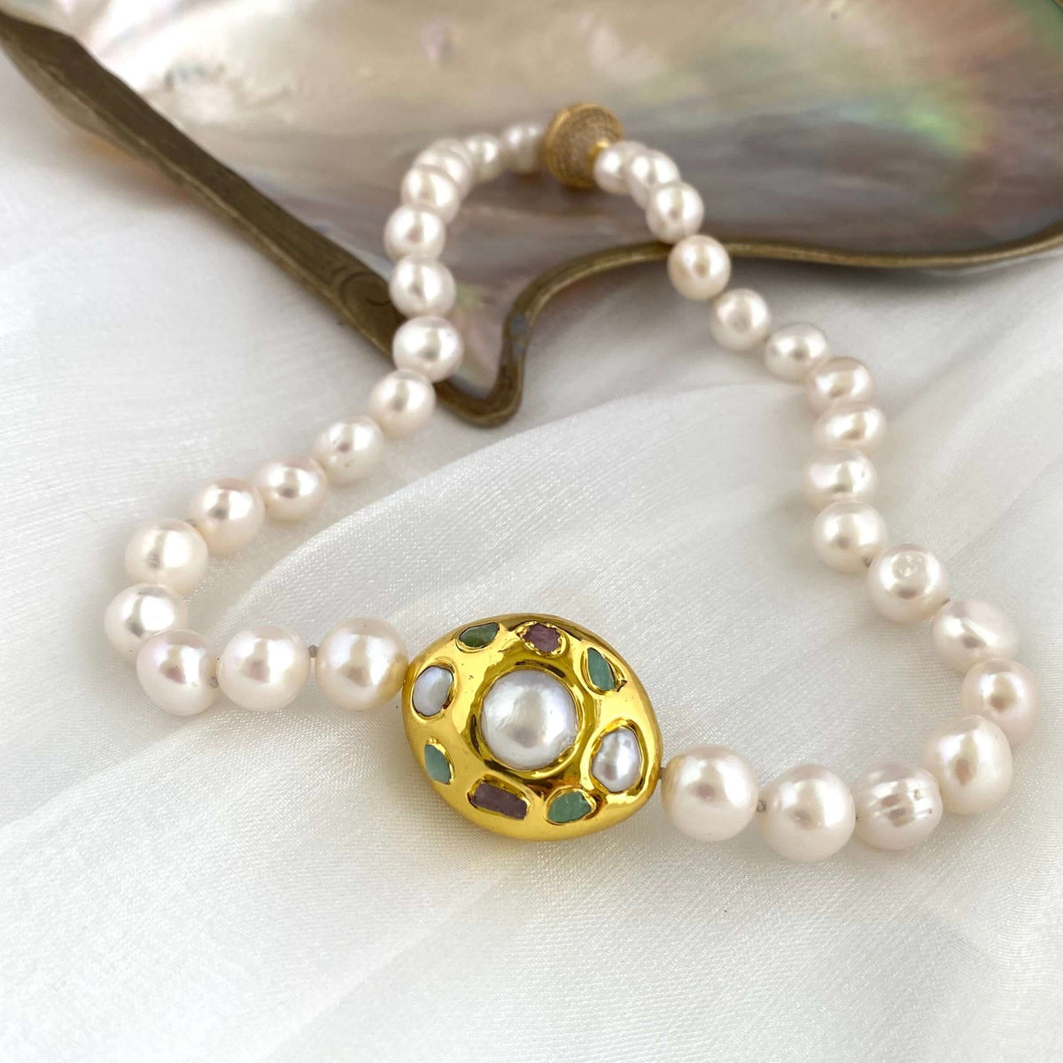 White pearl necklace with gold accent featuring hand-knotted freshwater pearls and an elegant gold focal accent.