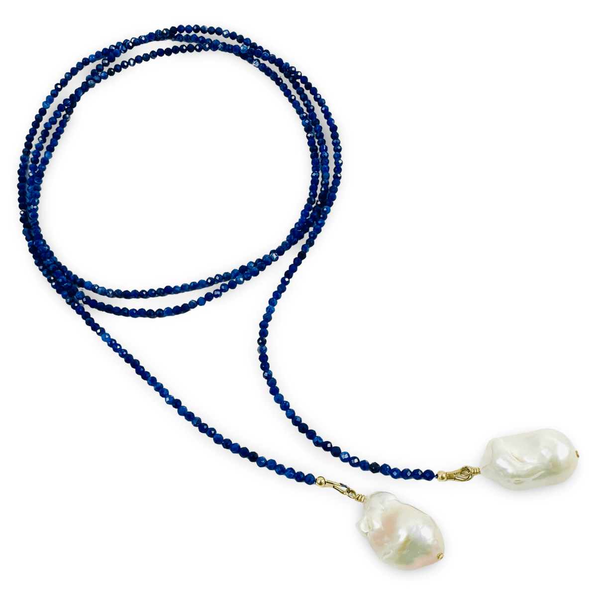 A beaded necklace featuring a strand of deep blue faceted beads and two large, irregular white baroque pearls suspended from gold-toned rings, displayed on a clean white background.