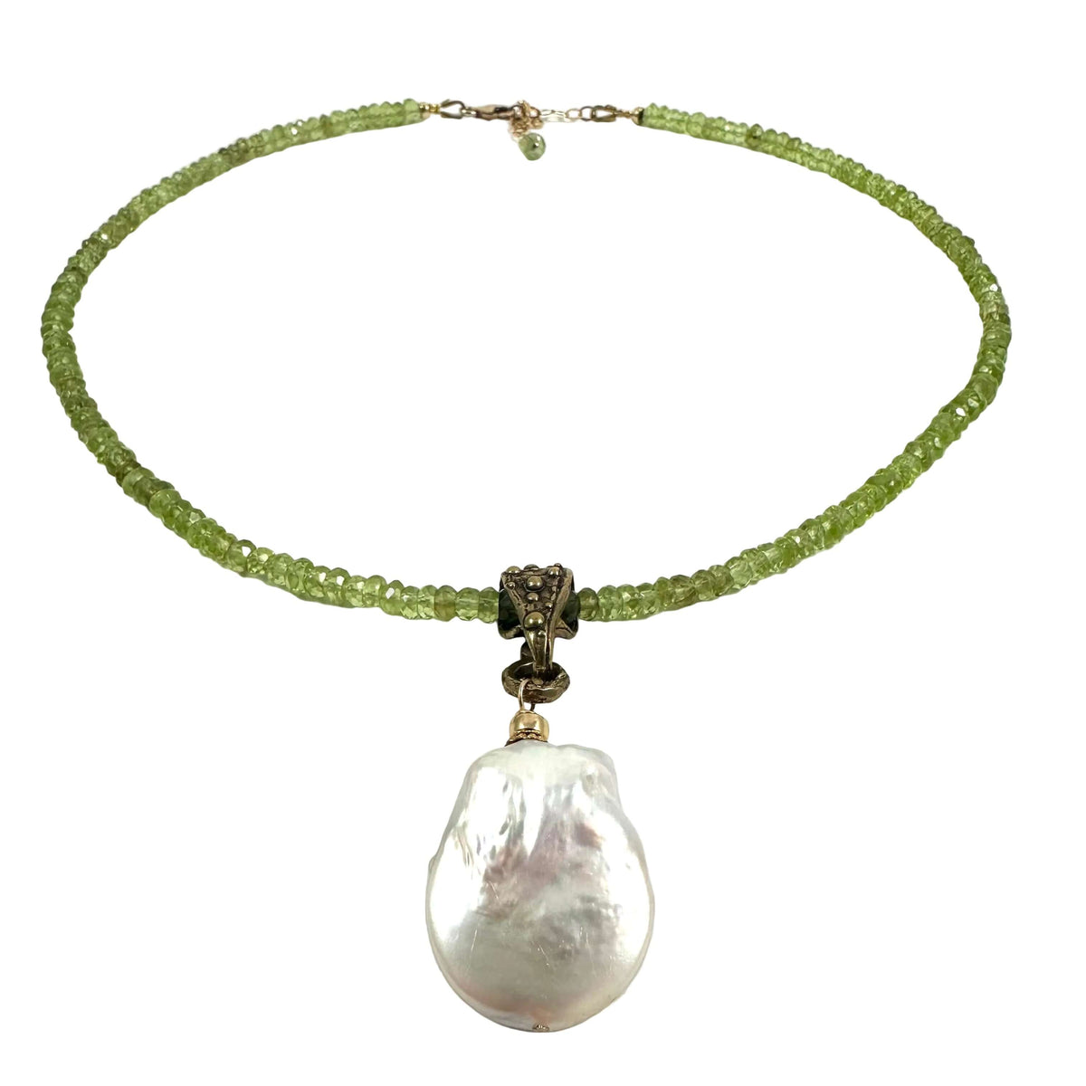 A beaded necklace featuring a strand of light green faceted beads, a bronze-toned central connector, and a large, irregular white baroque pearl pendant, displayed on a clean white background.