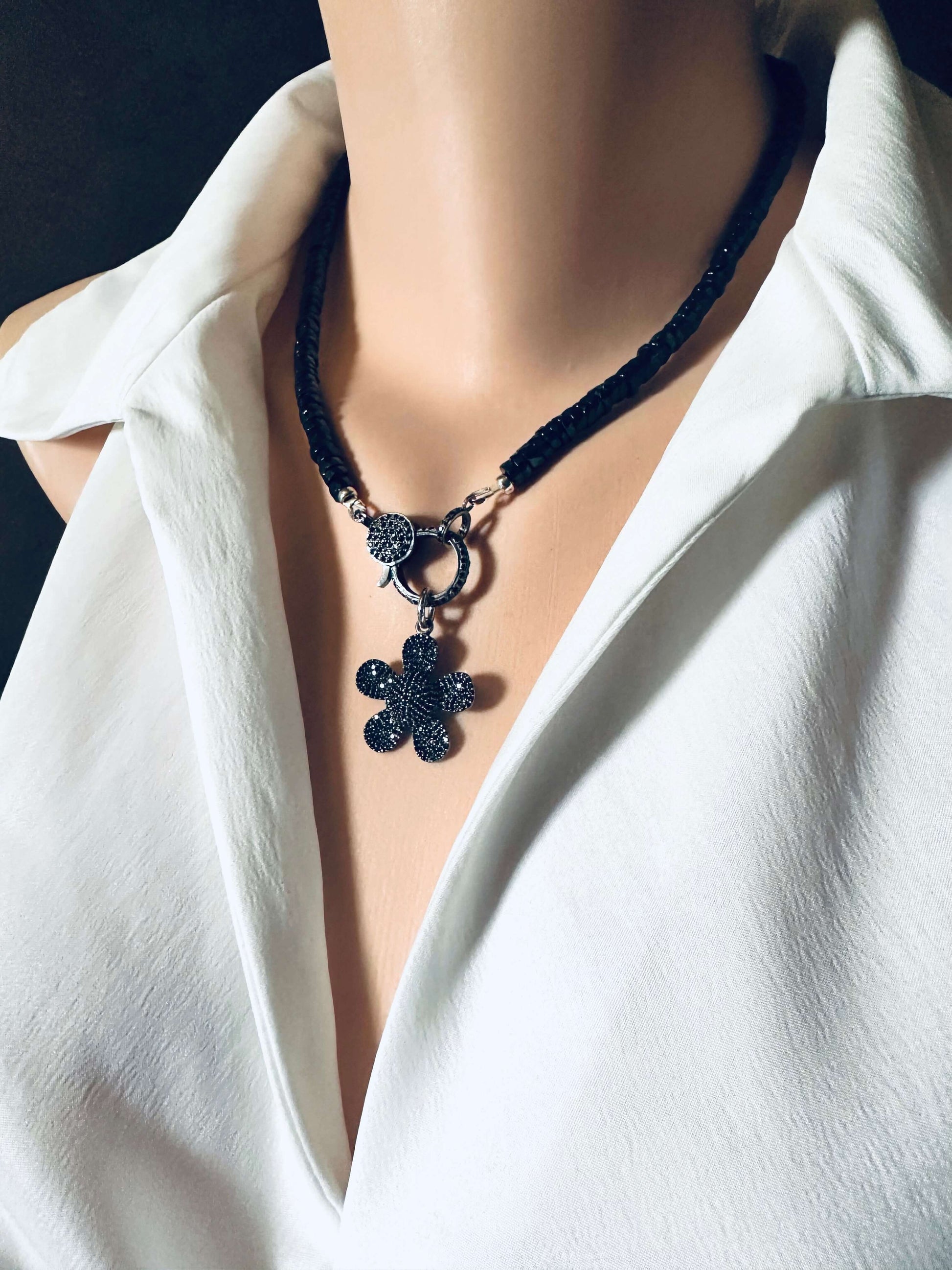 Black Spinel Daisy Pendant Necklace in Oxidized Silver – 18" showcased on a mannequin with a white blouse.