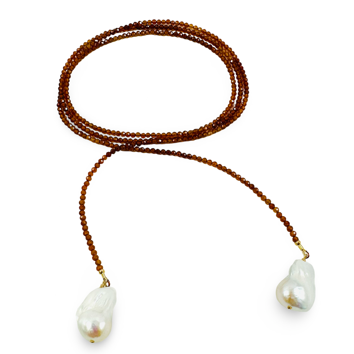 A beaded necklace with a double strand of warm brown beads and a third strand of smaller gold-toned beads, featuring two large white baroque pearls at the ends, displayed on a clean white background.