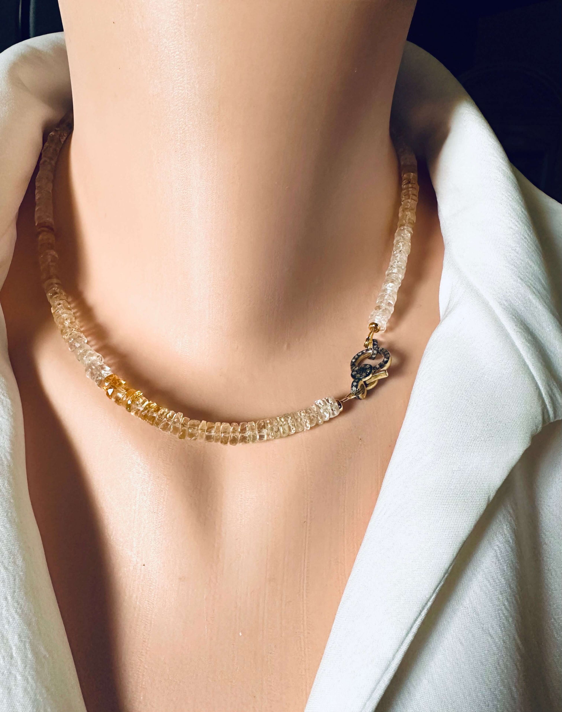 Shaded citrine gemstone necklace featuring a diamond pavé gold vermeil clasp, displayed elegantly on a mannequin.