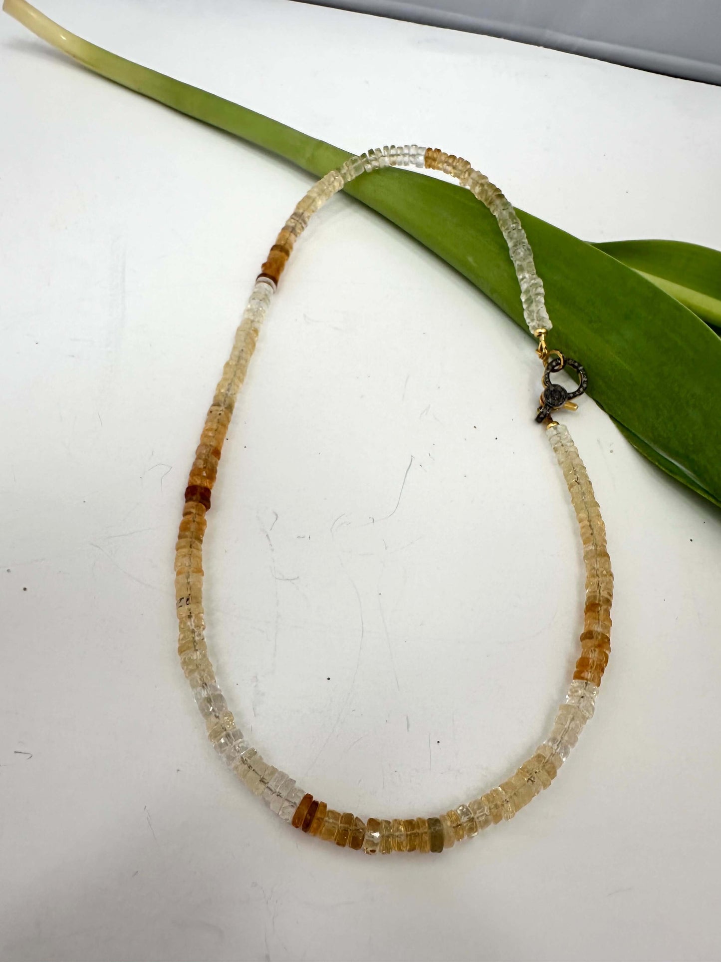 Shaded citrine gemstone necklace with a diamond pavé gold vermeil clasp showcasing warm golden hues.