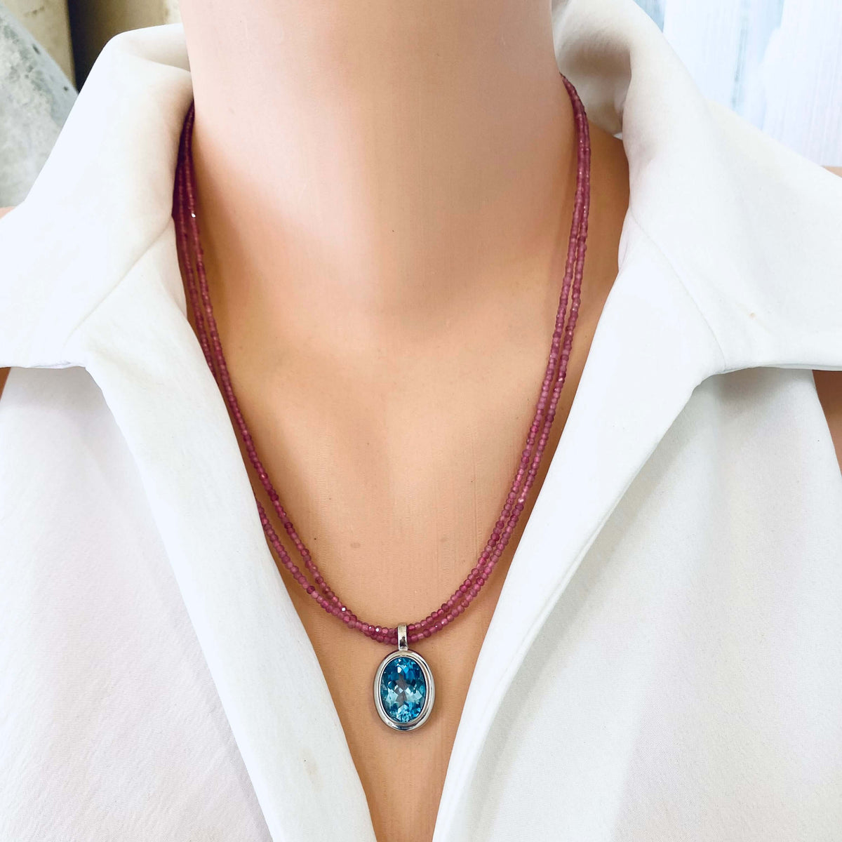 Pink Tourmaline Blue Topaz Pendant displayed on a model, showcasing the double strand design by Loulia Pearl Jewelry.