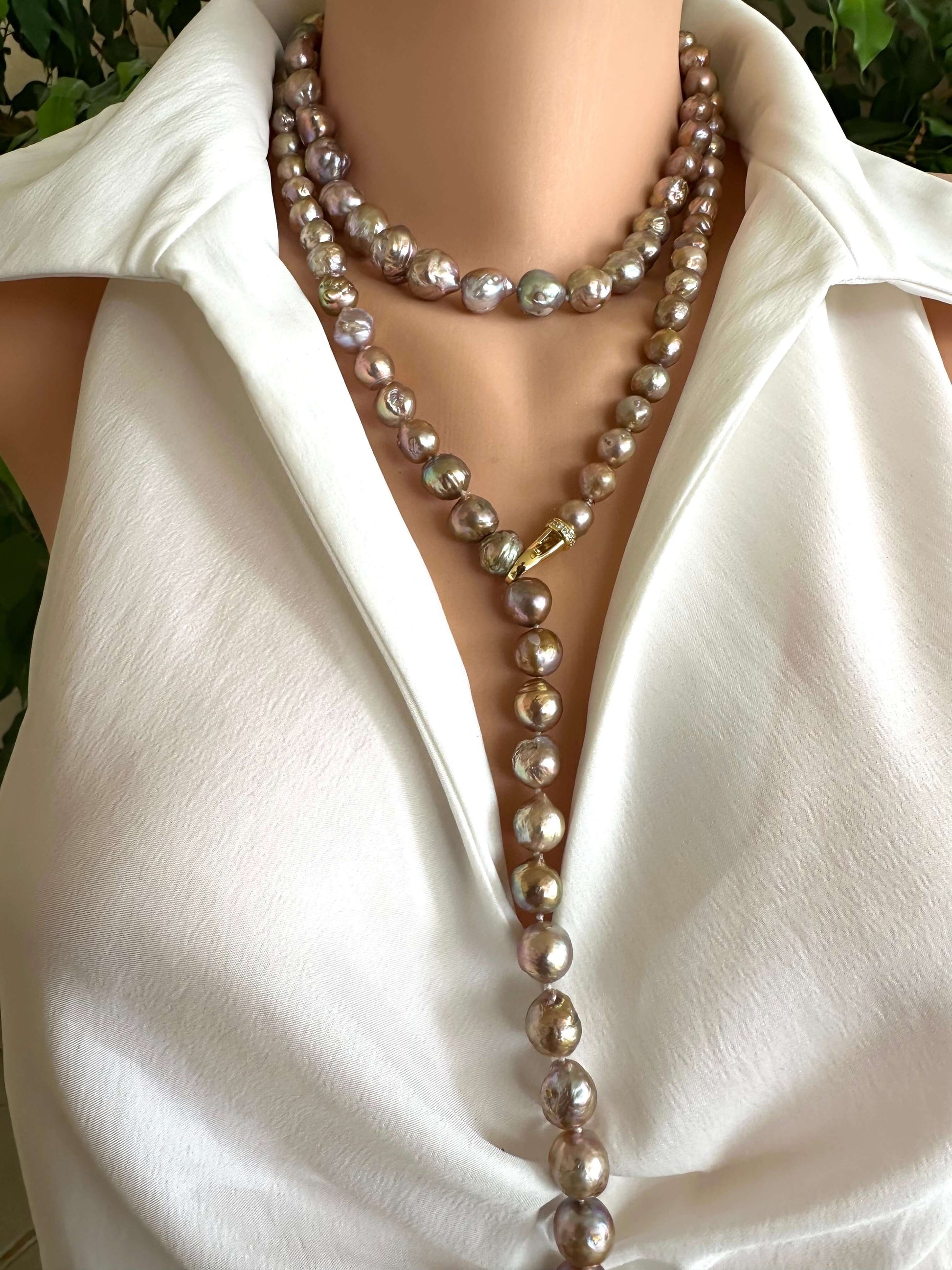 Mannequin wearing a white blouse with a pearl necklace