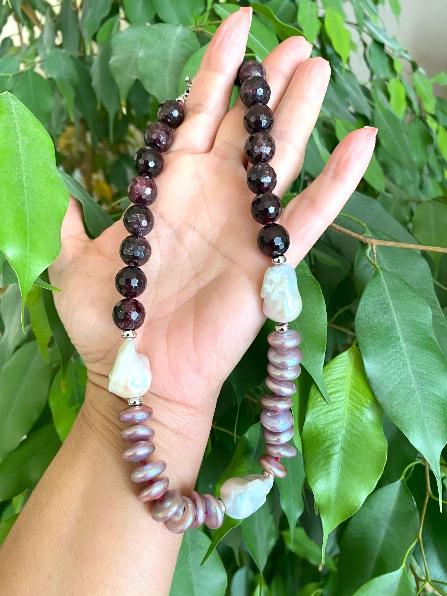 Garnet pearl necklace featuring faceted garnet beads and Baroque coin pearls, showcasing rich colors and elegant design.