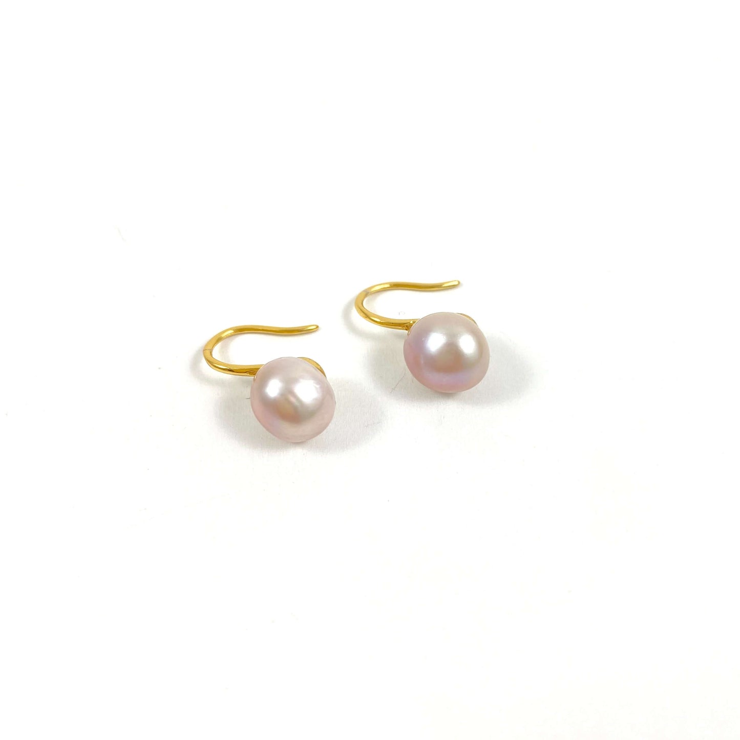 gold high heel earrings with pink pearls on white background