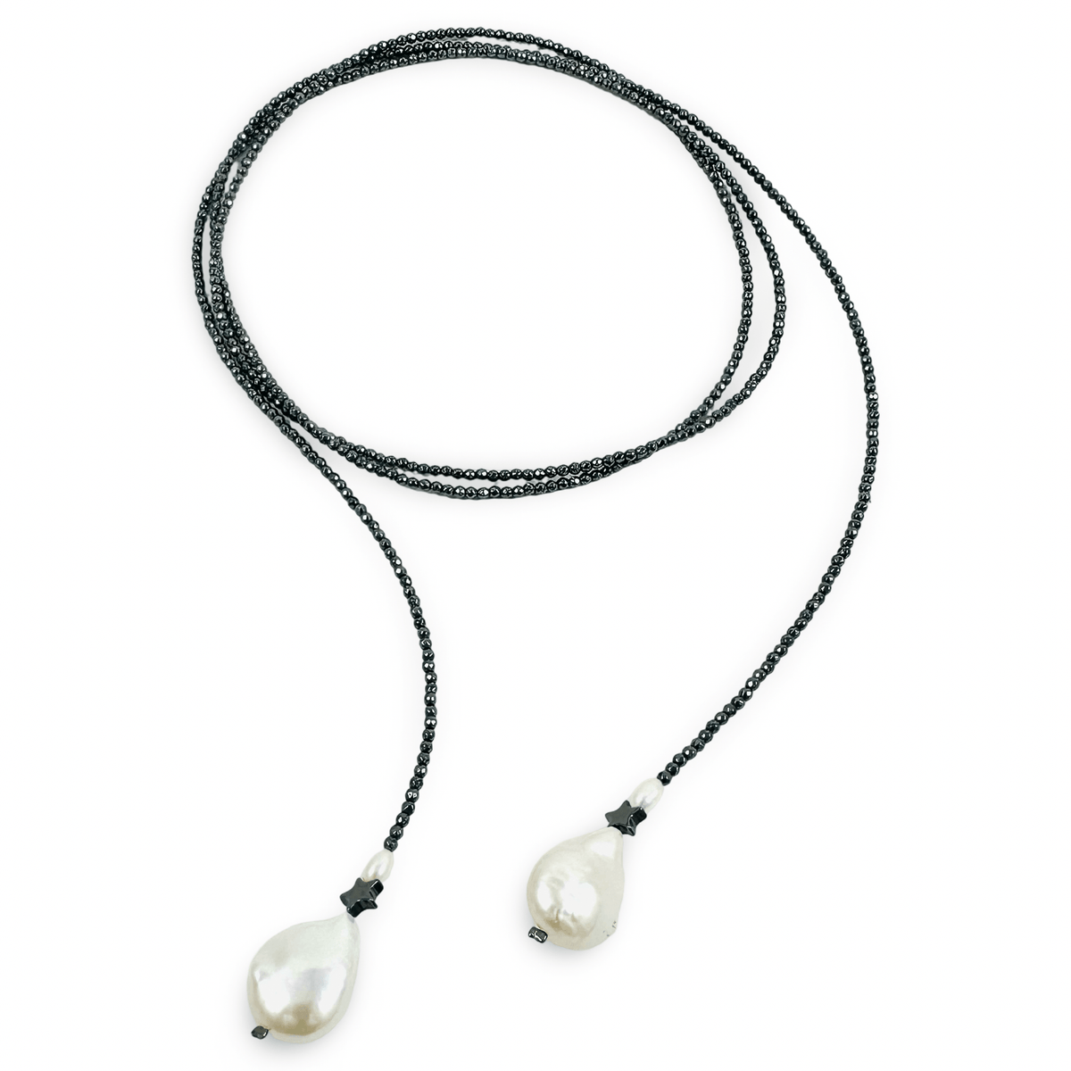 A long-strand beaded necklace with dark gray beads and two large, irregular white baroque pearls at the ends, displayed on a clean white background.