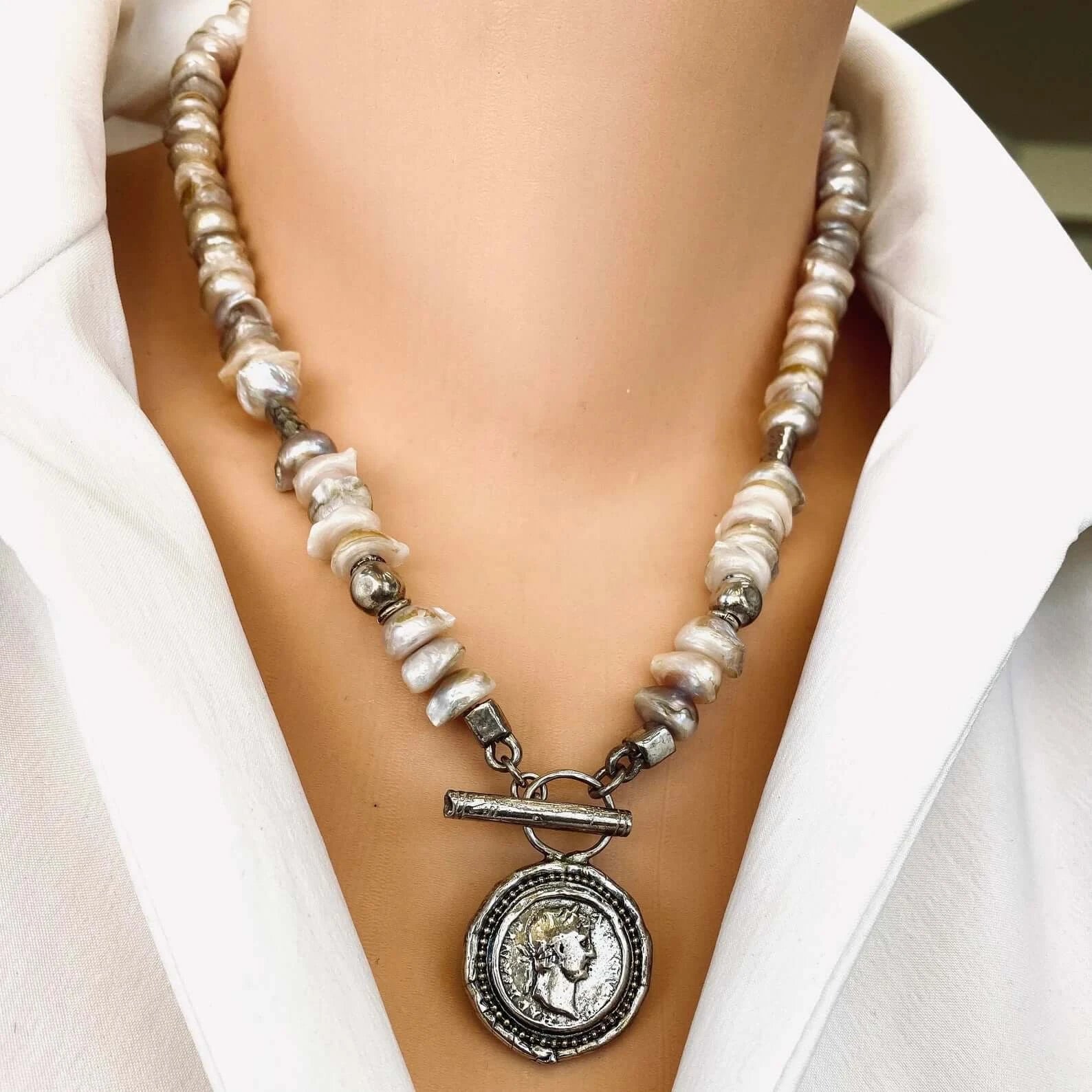 Lavender baroque pearl necklace with silver Roman coin toggle clasp showcased on a model.