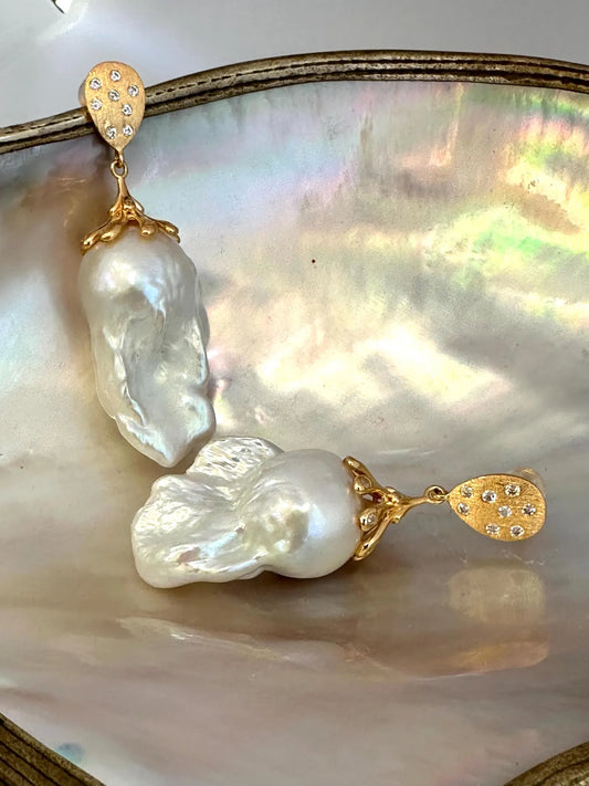Close-up of Baroque Pearl Gold Vermeil Earrings on white pearl backdrop — handcrafted statement jewelry by Loulia Pearl Jewelry