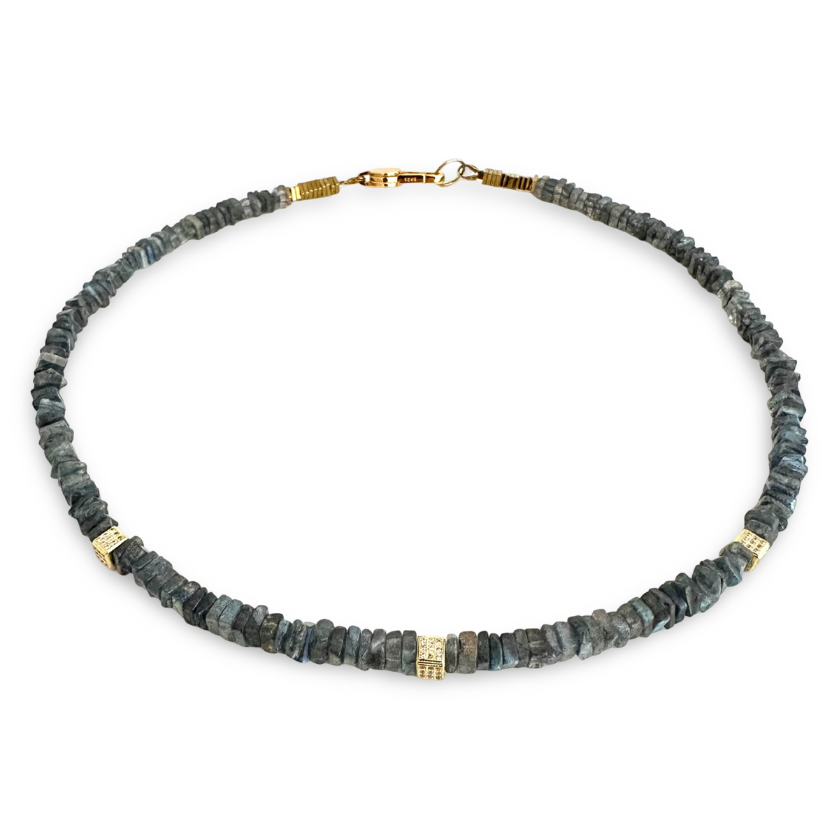 A raw stone disc necklace featuring dark gray and blue-gray lapis lazulii with small gold spacer beads and a gold lobster clasp, shown on a plain white background.