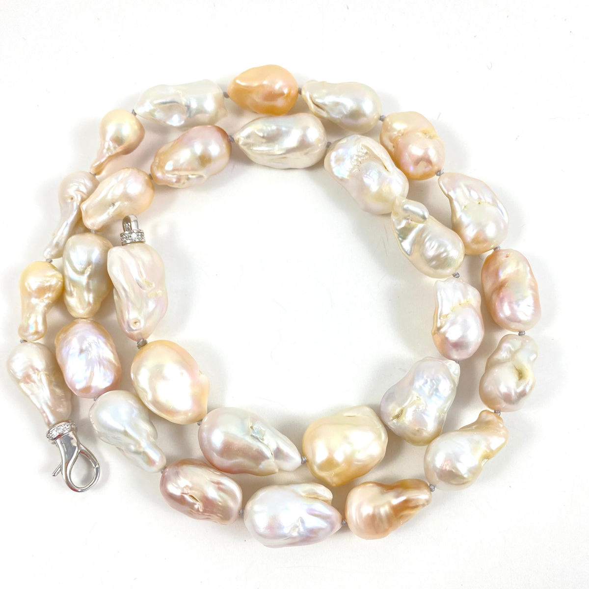 Hand knotted with large freshwater baroque pearls in natural shades of white, ivory, beige and soft blush, this 29-inch necklace brings together dramatic size and effortless versatility.