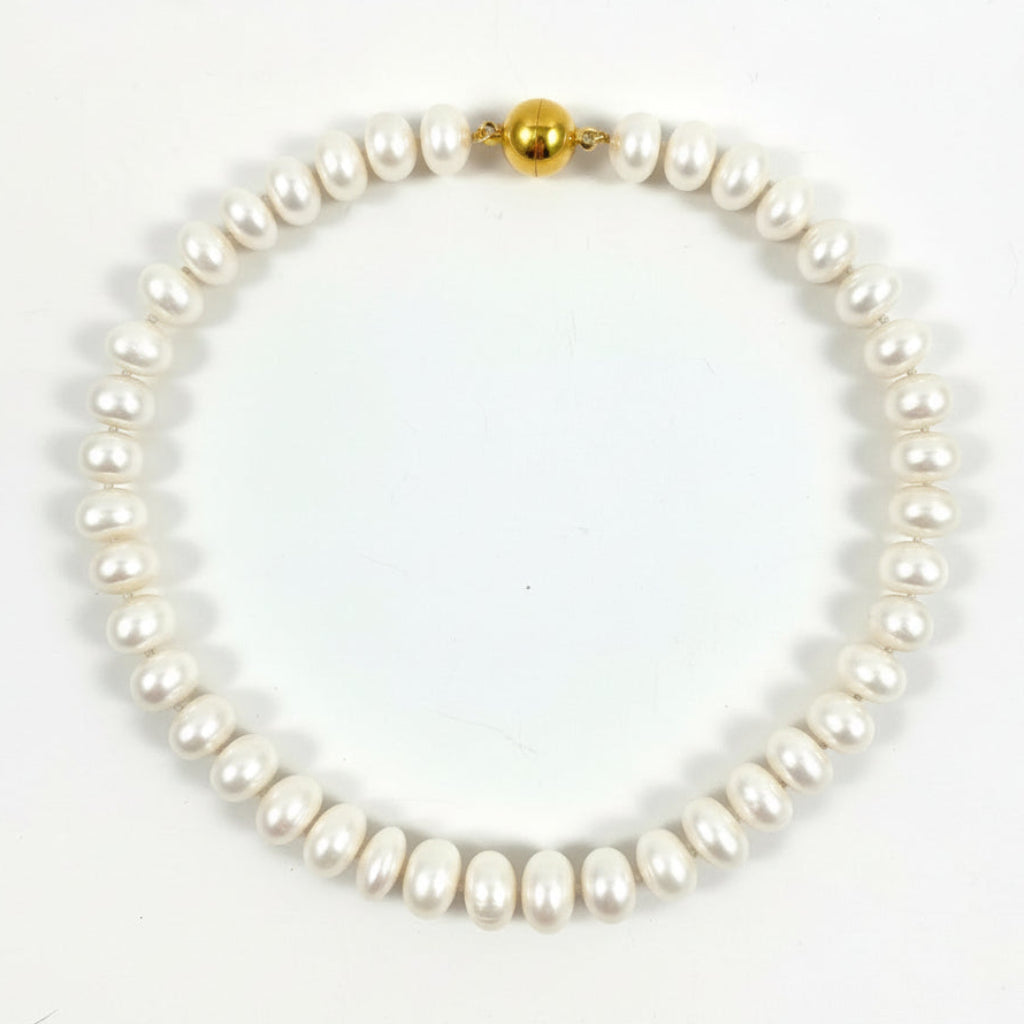 A single-strand baroque pearl necklace with a polished gold bead clasp, displayed on a clean white background.