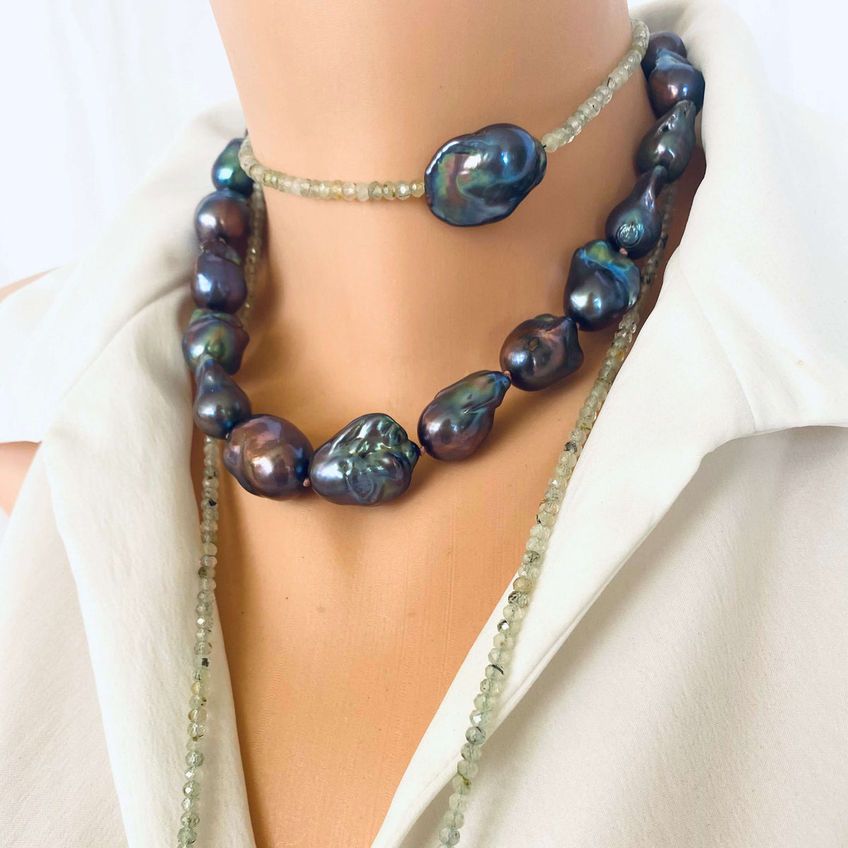 Green Prehnite and Black Baroque Pearls Lariat Necklace on a mannequin showcasing a blend of soft greens and lustrous blacks.