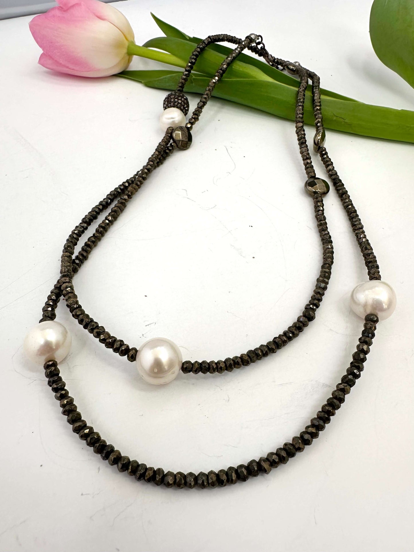 Long pyrite and pearl necklace with pavé accent in oxidized silver, featuring faceted pyrite beads and freshwater pearls.