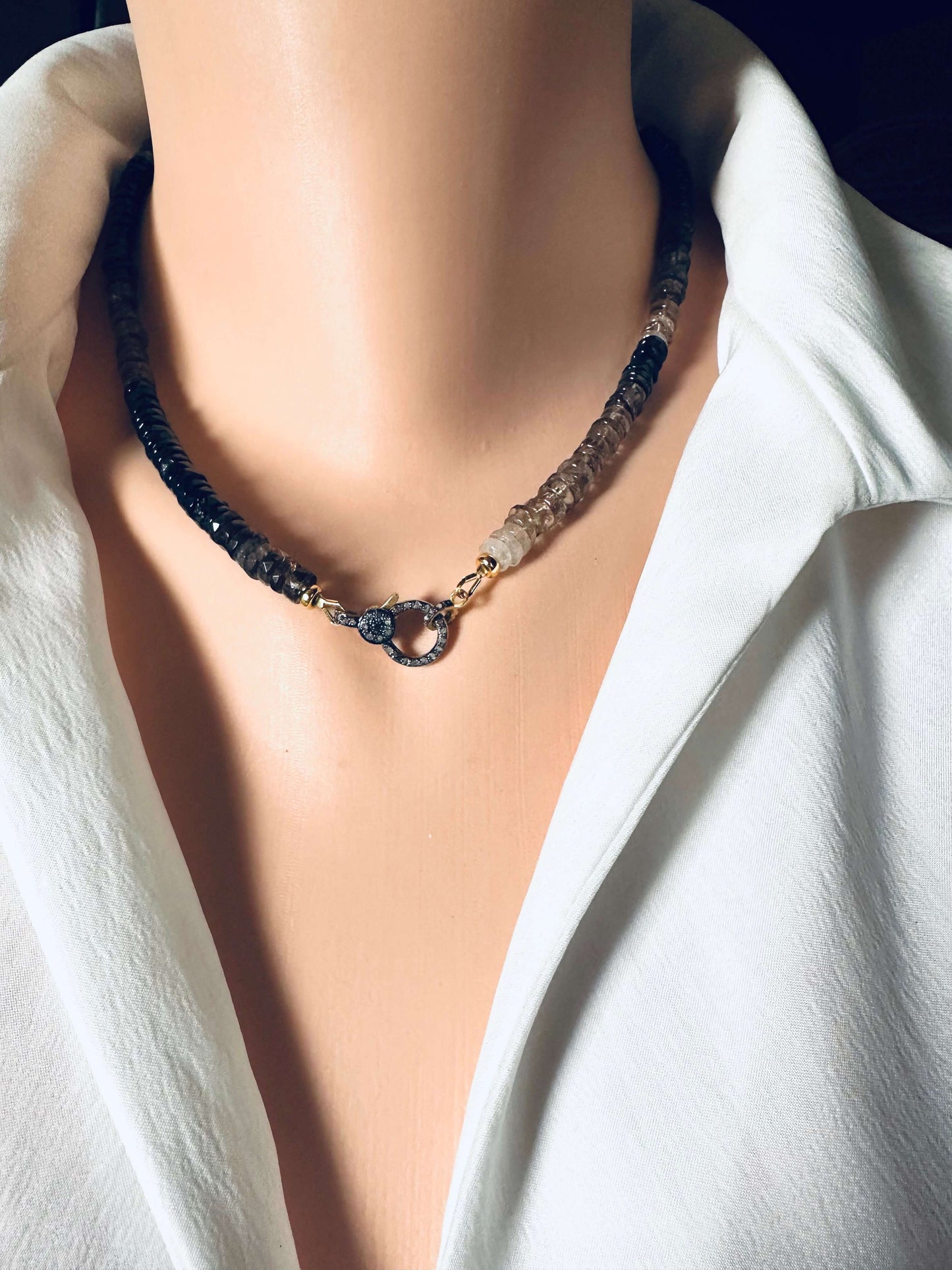 Smoky quartz necklace with pavé clasp showcased on a mannequin, featuring faceted beads and gold vermeil clasp.