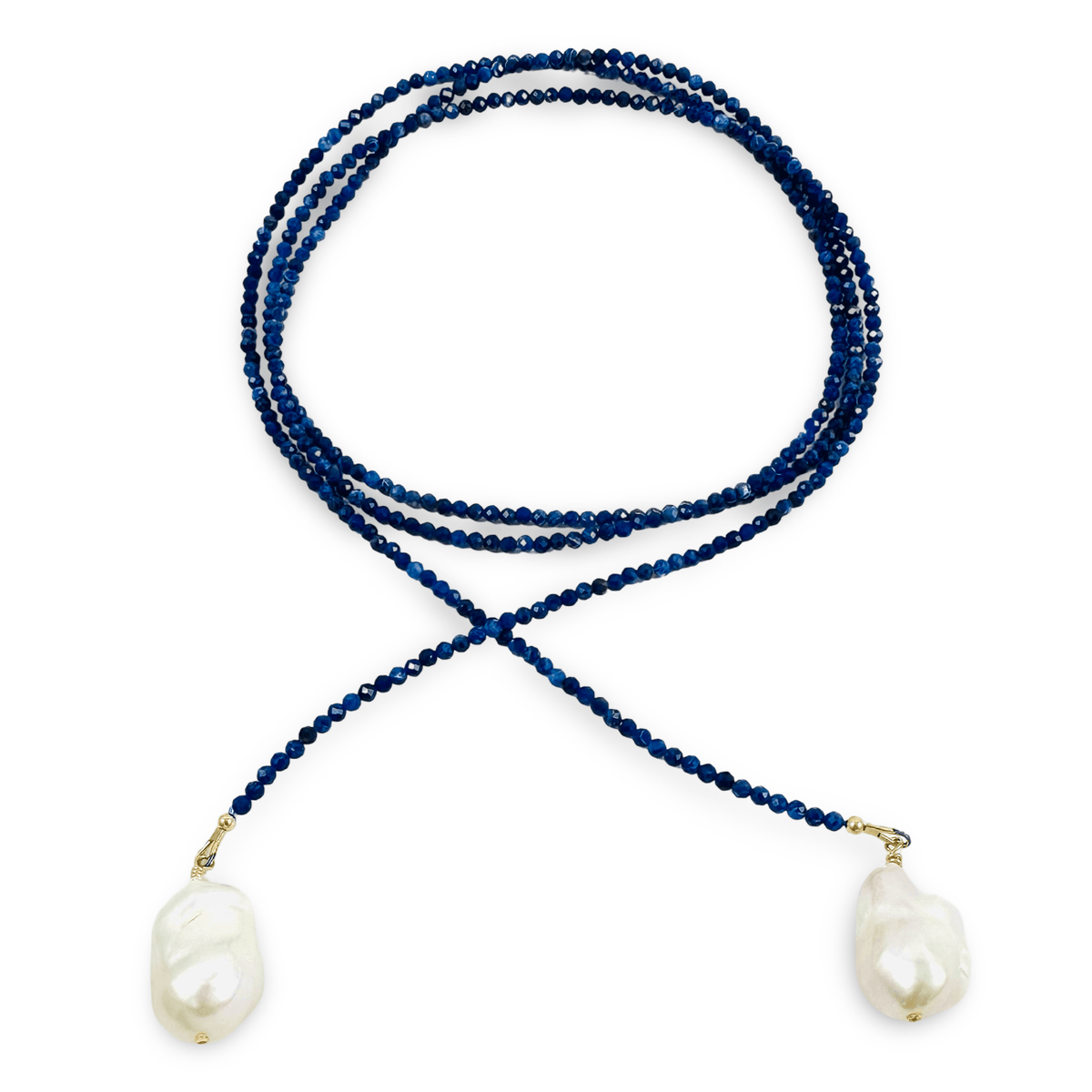 A beaded necklace featuring dark blue faceted beads and two large, irregular white baroque pearls, displayed on a clean white background.