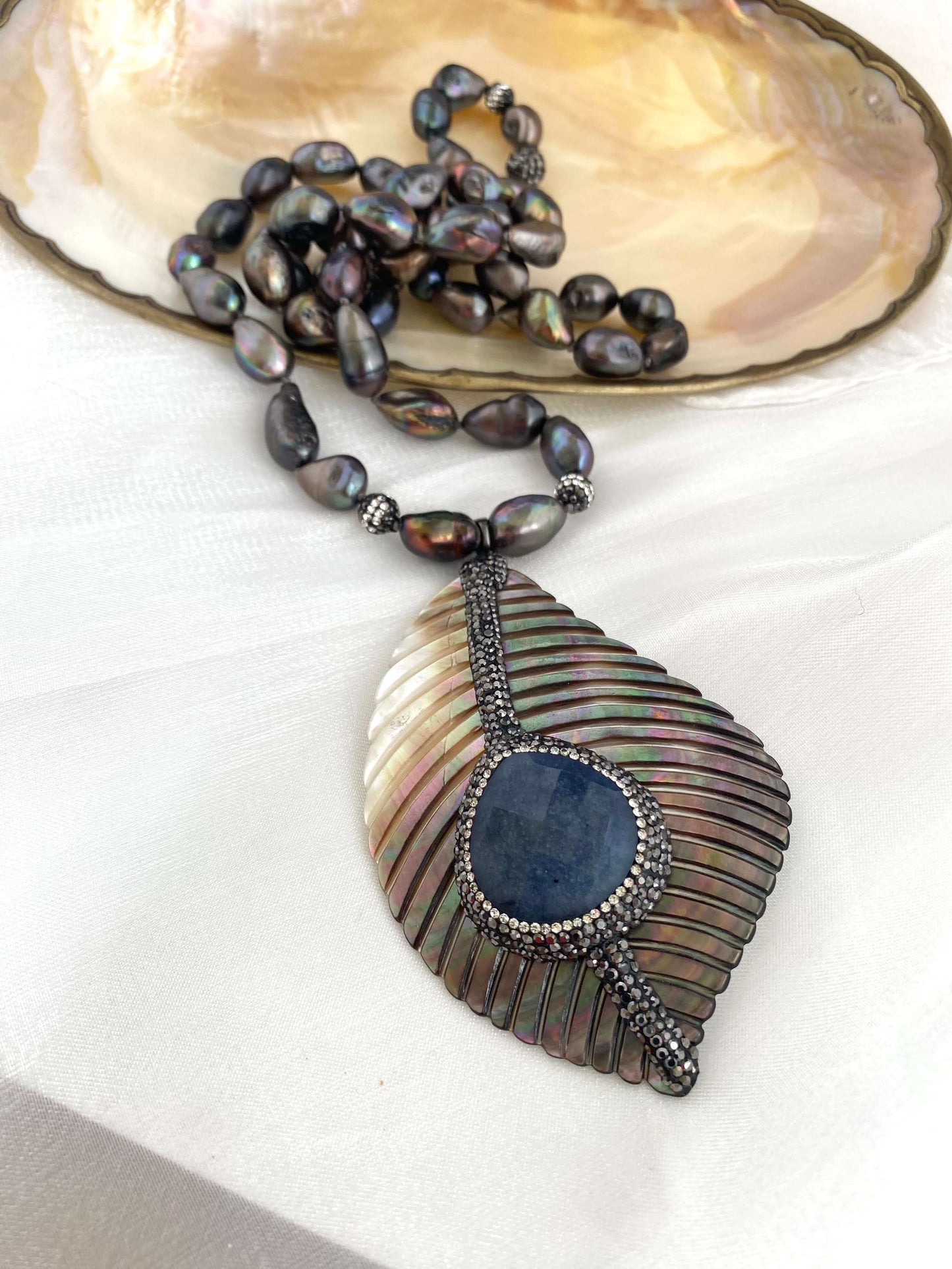 Necklace with a pendant on a shell background