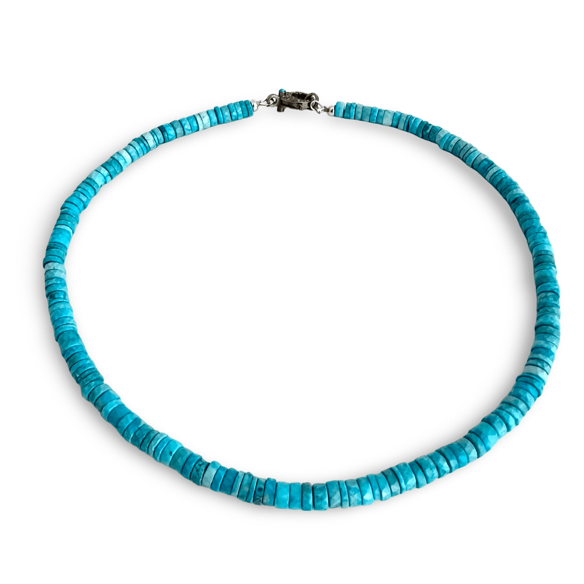 A turquoise beaded necklace made of small, flat, disc-like turquoise pieces, featuring a dark metal clasp, shown on a plain white background.