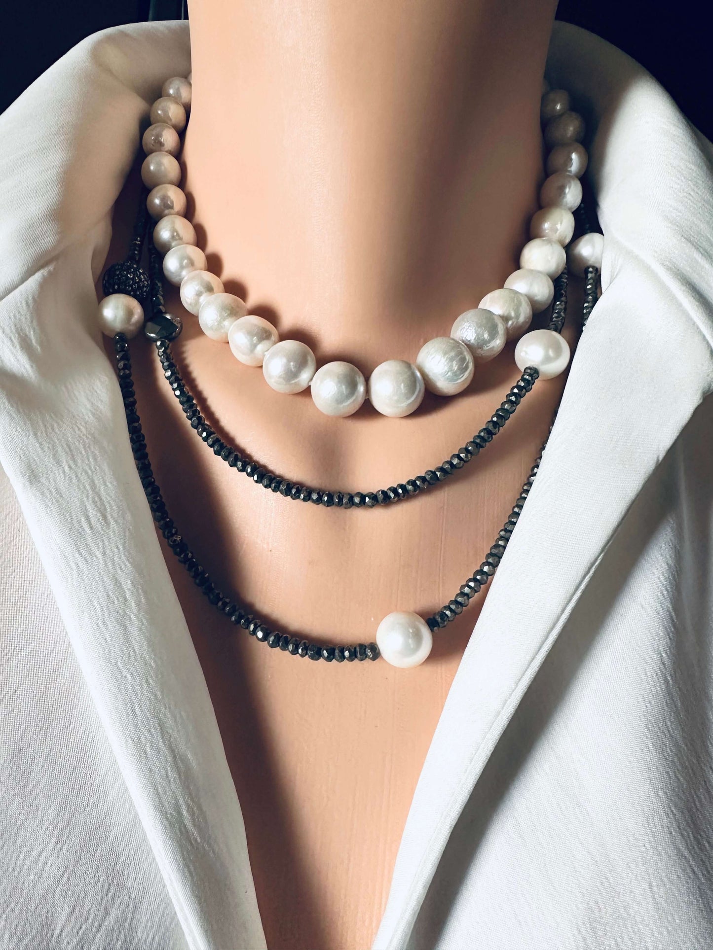Long pyrite and pearl necklace displayed elegantly with white freshwater pearls and sparkling pyrite beads.
