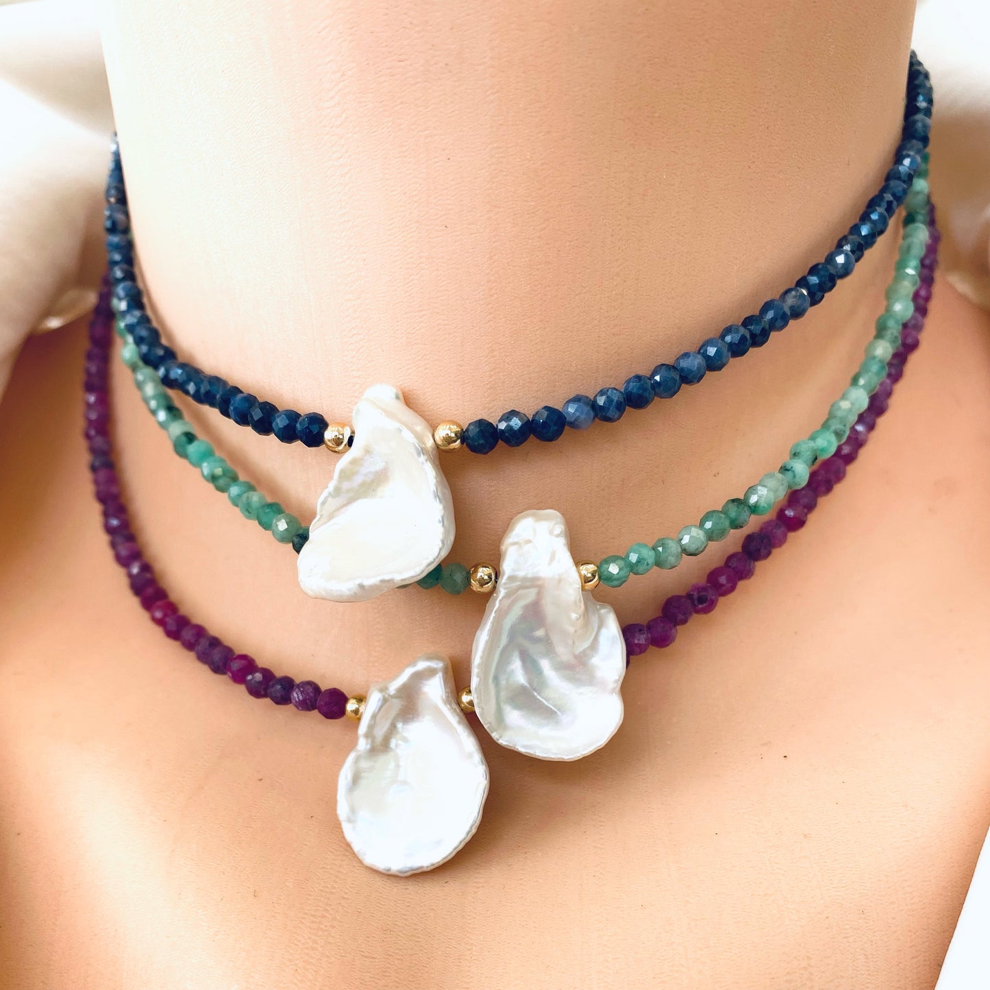 Ruby keshi pearl choker necklace layered with gemstone chokers and freshwater keshi pearl