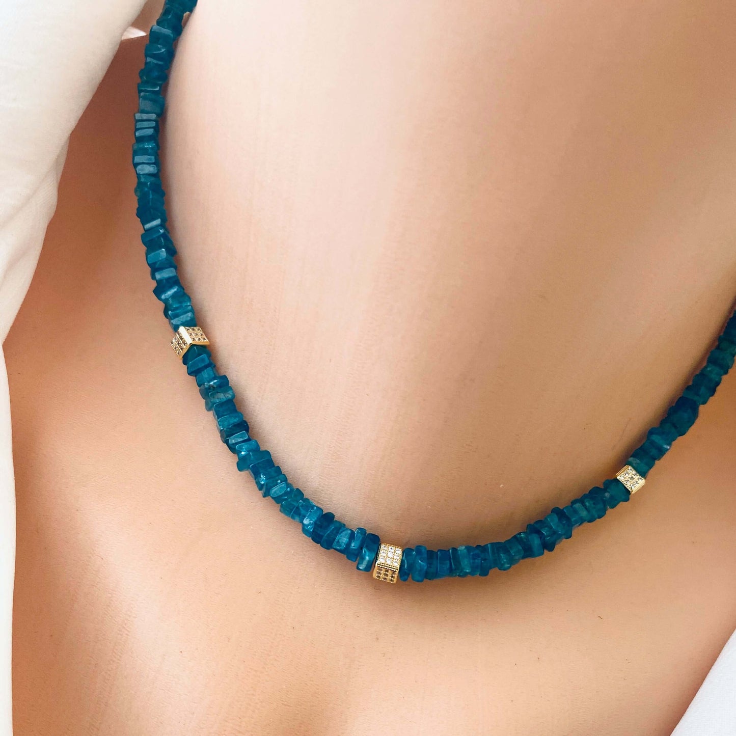 Blue Apatite Choker Necklace with Faceted Beads showcasing rich ocean-blue hues and gold accents.