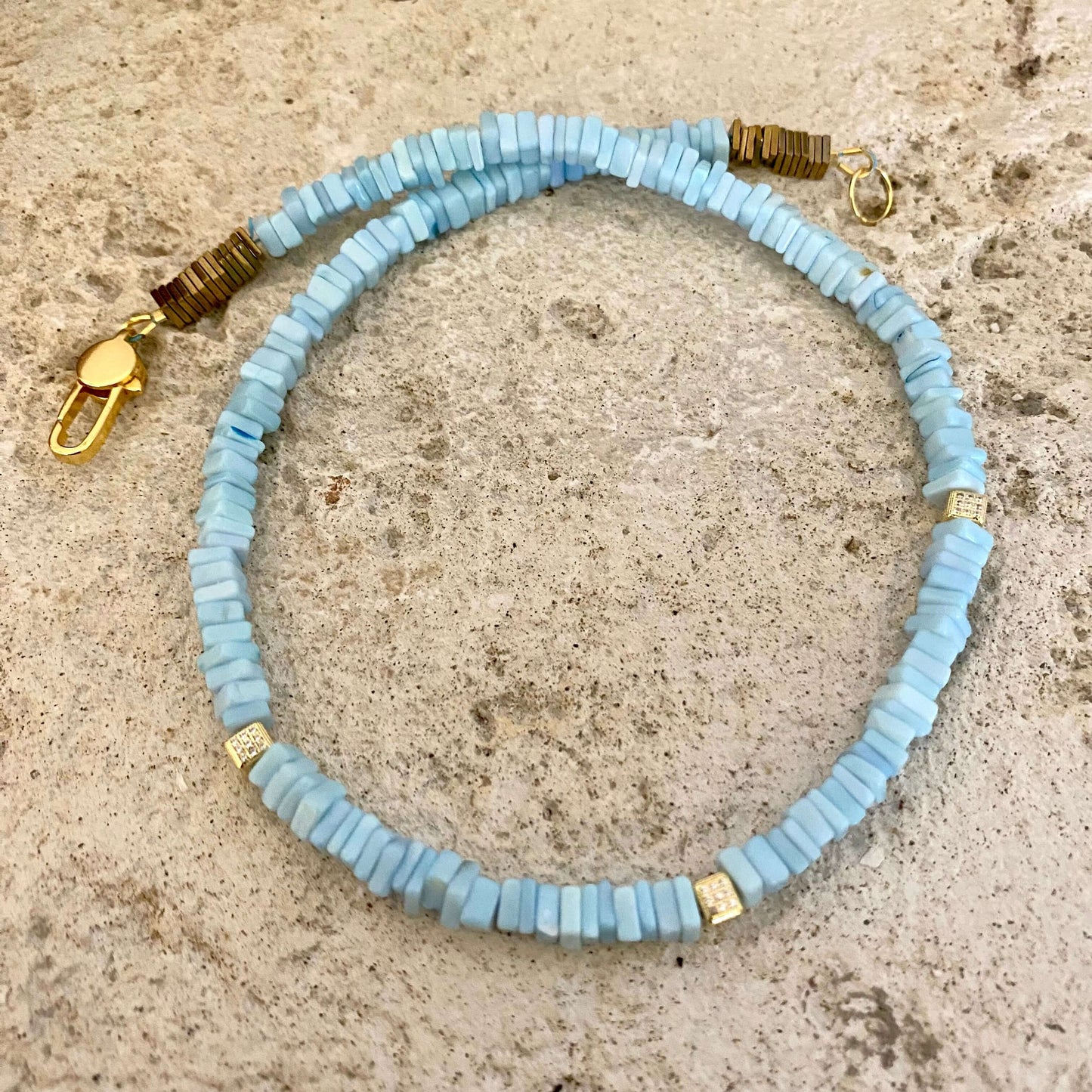 Blue Opal Choker Necklace with Peruvian Opal Beads showcased on a textured stone surface.