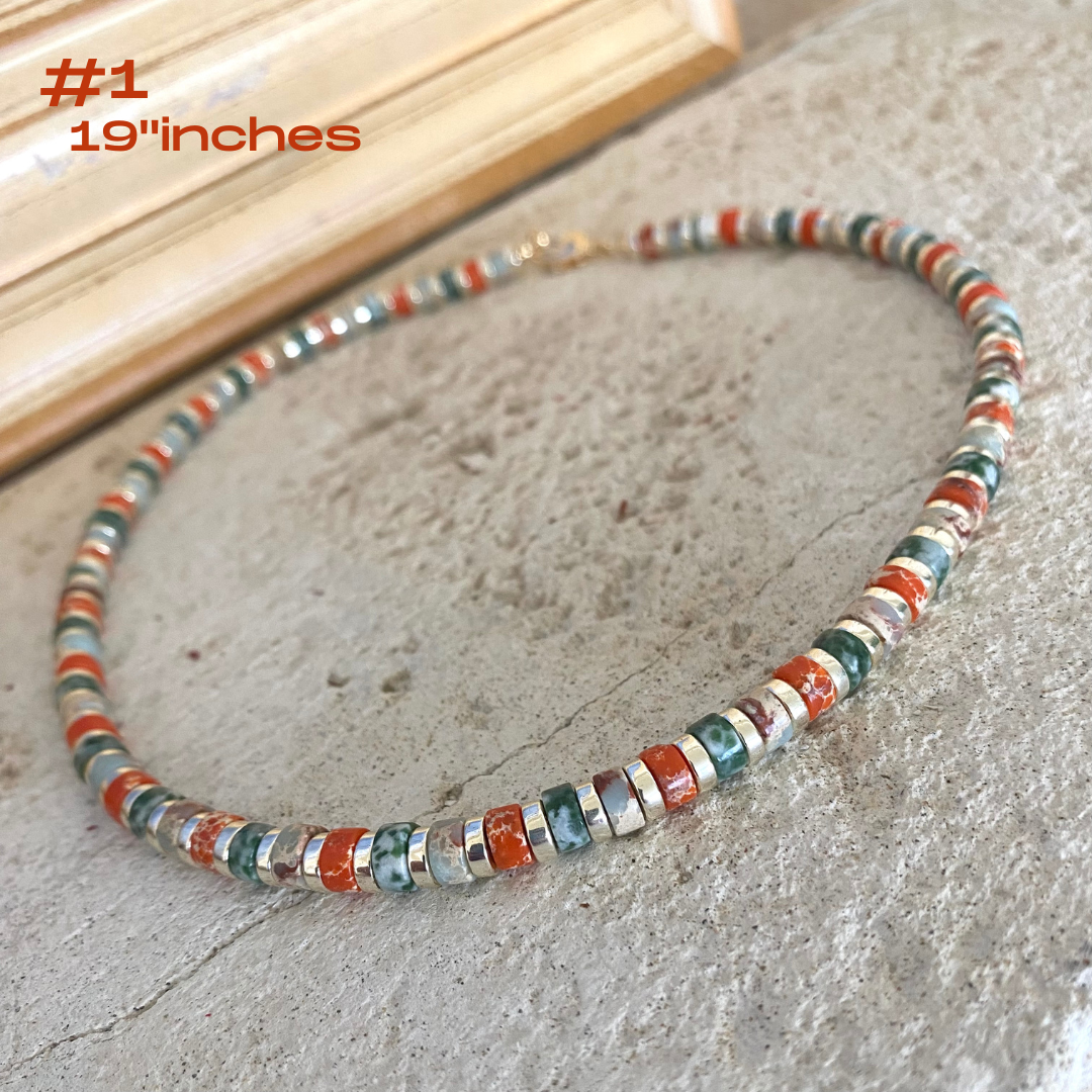Gemstone choker necklace featuring multi color beads and hematite, handcrafted with vibrant tube-shaped gemstones.