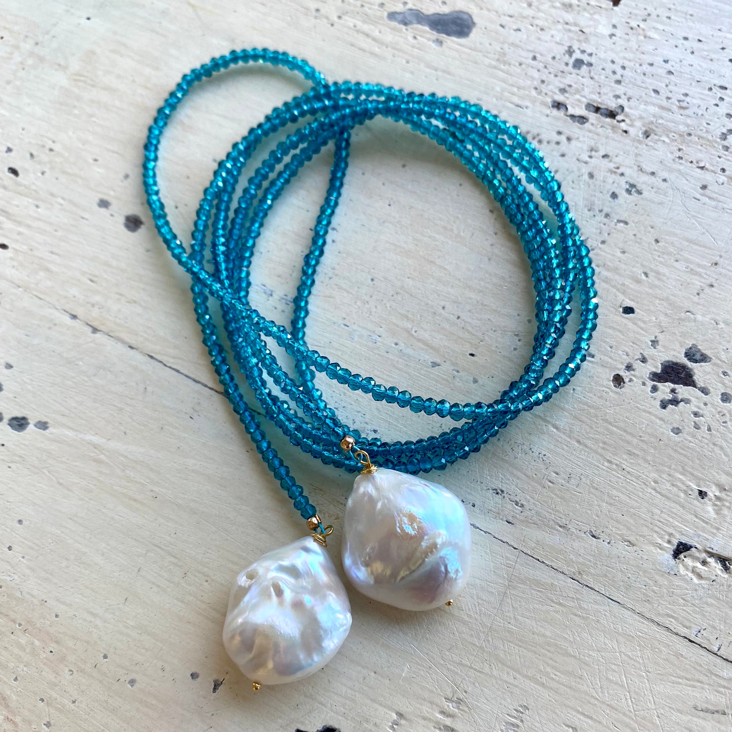 London Blue Quartz Lariat Necklace flat lay, coiled blue quartz beads with two baroque pearls