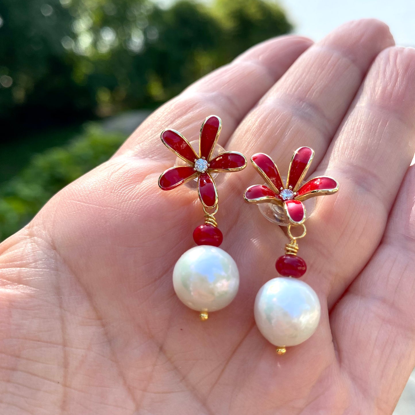 Edison pearl coral earrings showing red enamel flower design and luminous white pearls