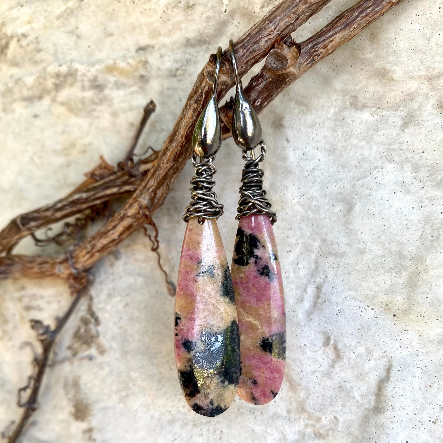 Rhodonite Teardrop Earrings – Black Rhodium Finish featuring unique pink and black veined rhodonite stones.
