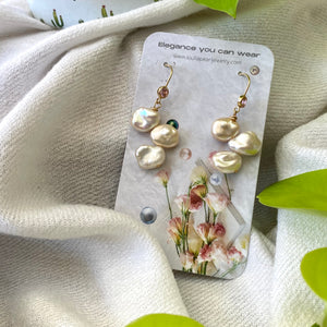 Elegant earrings composed of Natural Keshi pink and white pearls hanging from gold filled hooks with pink cubic zirconia bezel
