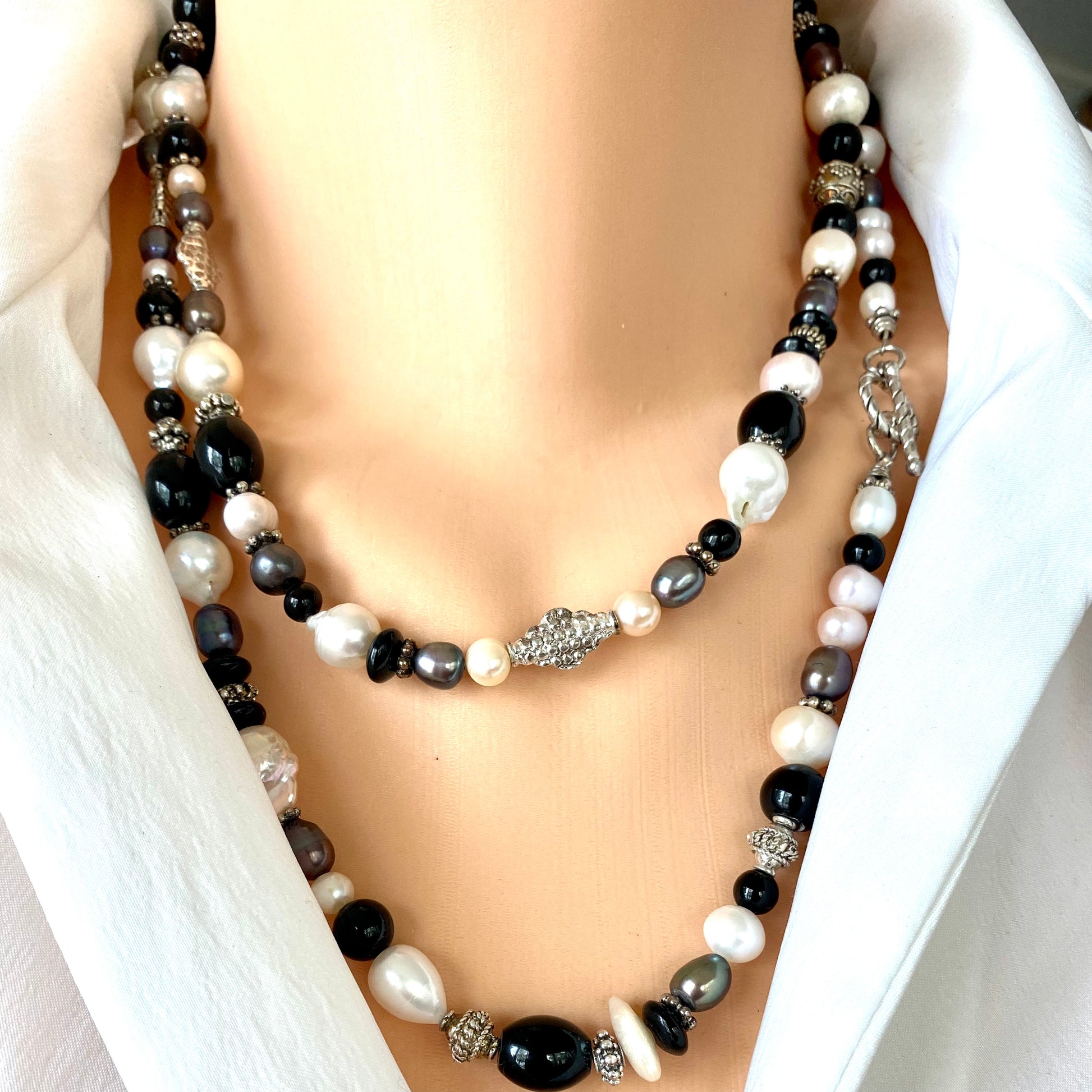 Black onyx pearl long necklace worn doubled for layering with pearls and onyx beads