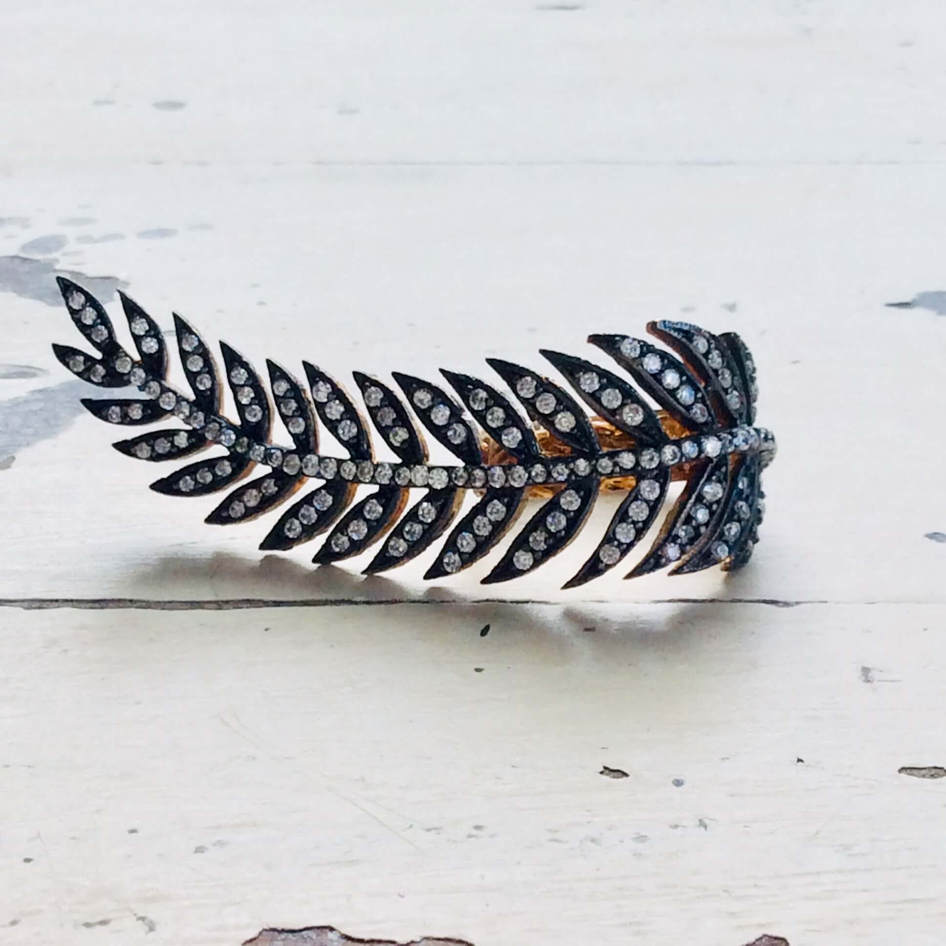 Vermeil leaf shape ring showcasing an antique finish and cubic zirconia embellishment, artistic gold statement jewelry.